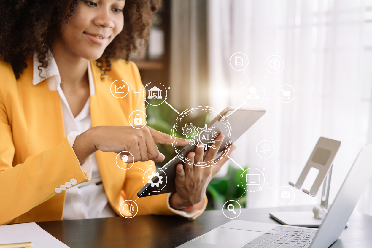 Woman selecting an AI tool on an ipad in the workplace.
