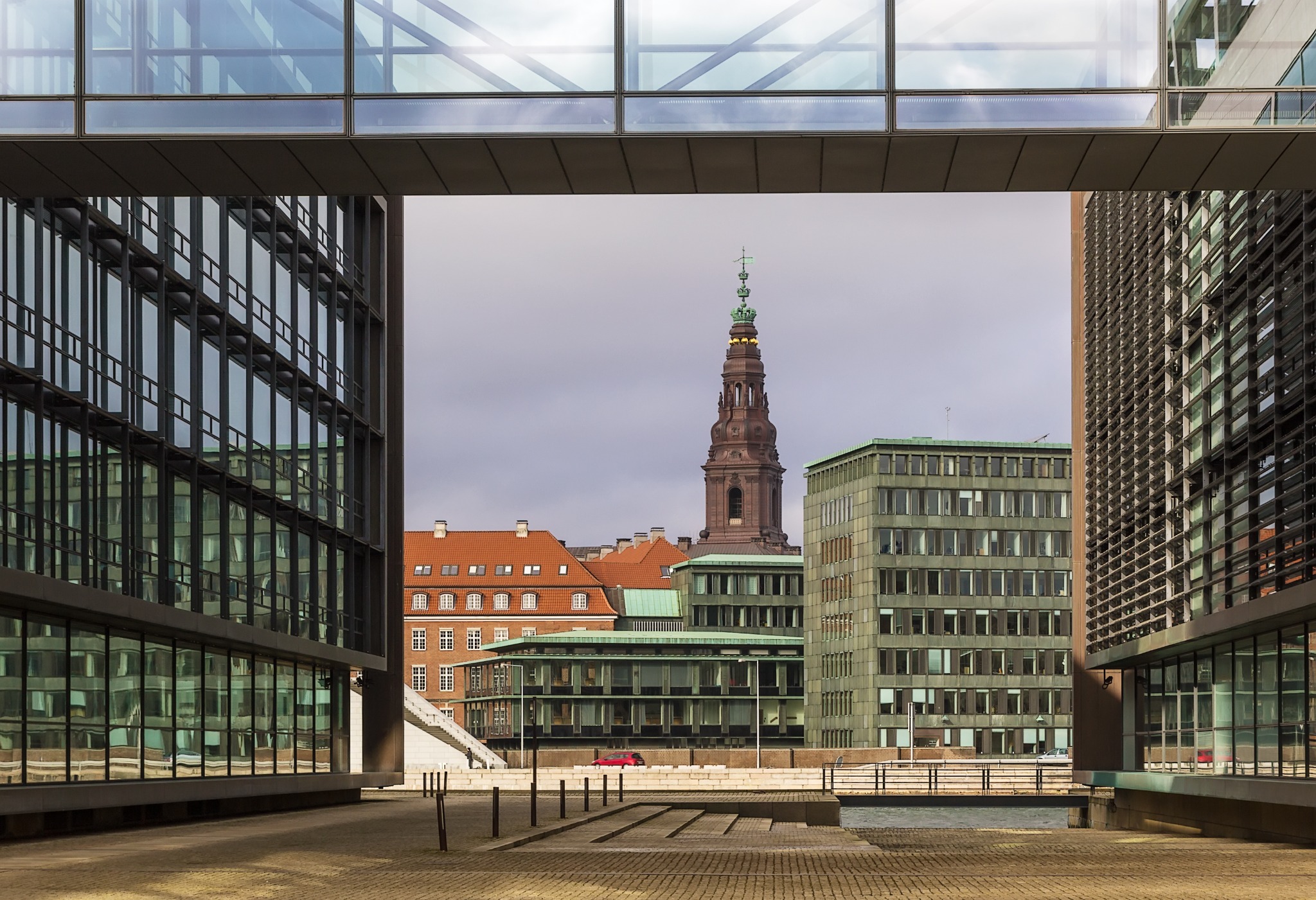 Christiansborg tower viewed between modern buildings