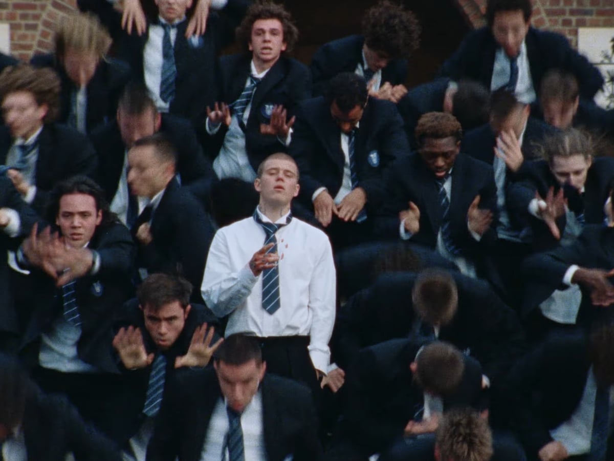 Yung Lean at the centre of the boarding school corridor — still from STORM by GENER8ION, directed by Romain Gavras (2026)
