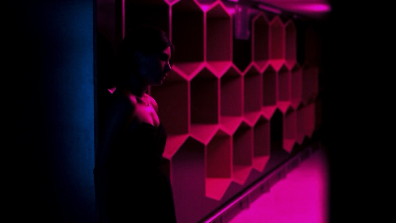 A figure in shadow beside a wall of magenta light, still from Hold On by Charlotte Scott-Wilson (2016)