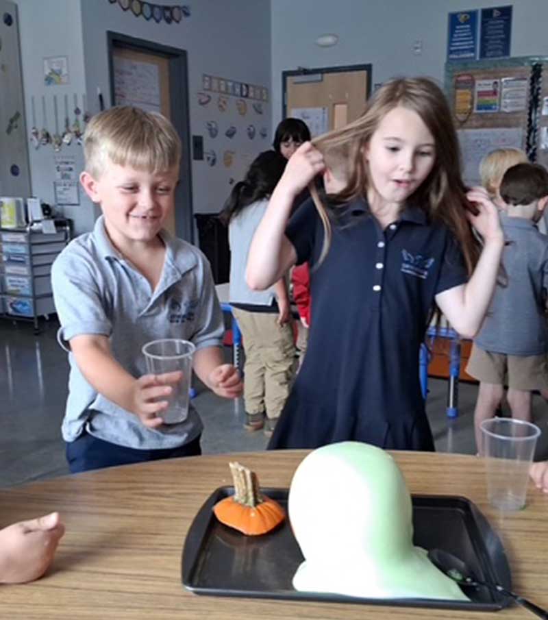 Two elementary students are excited about a project.