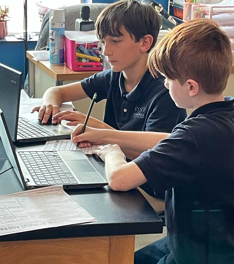 Two middle school students partner on a project.