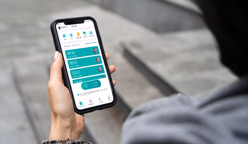 A man is using TruFace Manager Mobile Attendance App to check his attendance records