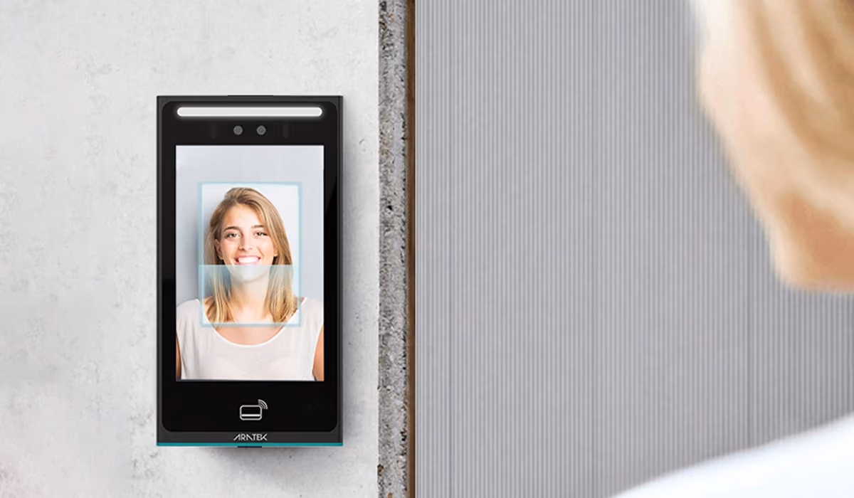 A woman is checking her access by a contactless facial recognition