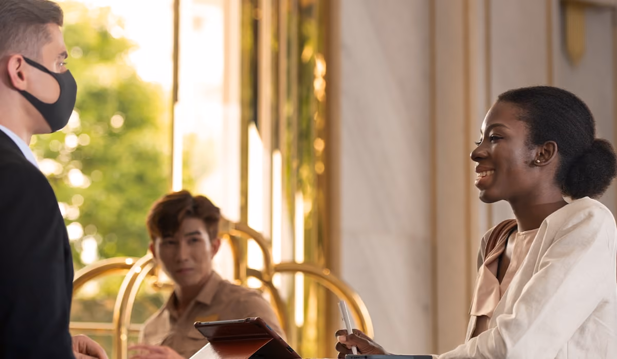 Enhanced hotel guest satisfaction and loyalty, showing by a smiling woman