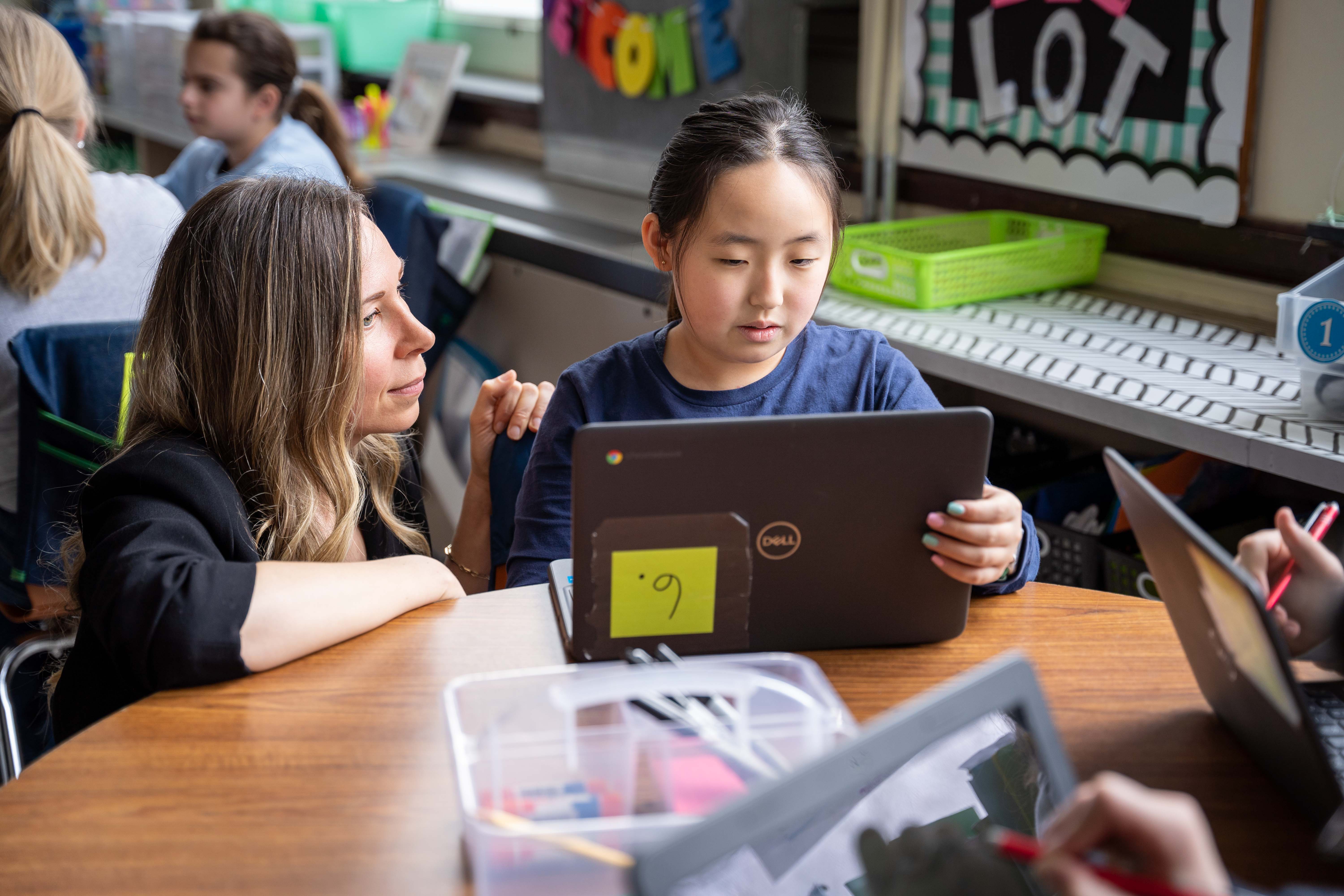 A teacher and a student is working with Magma on a laptop