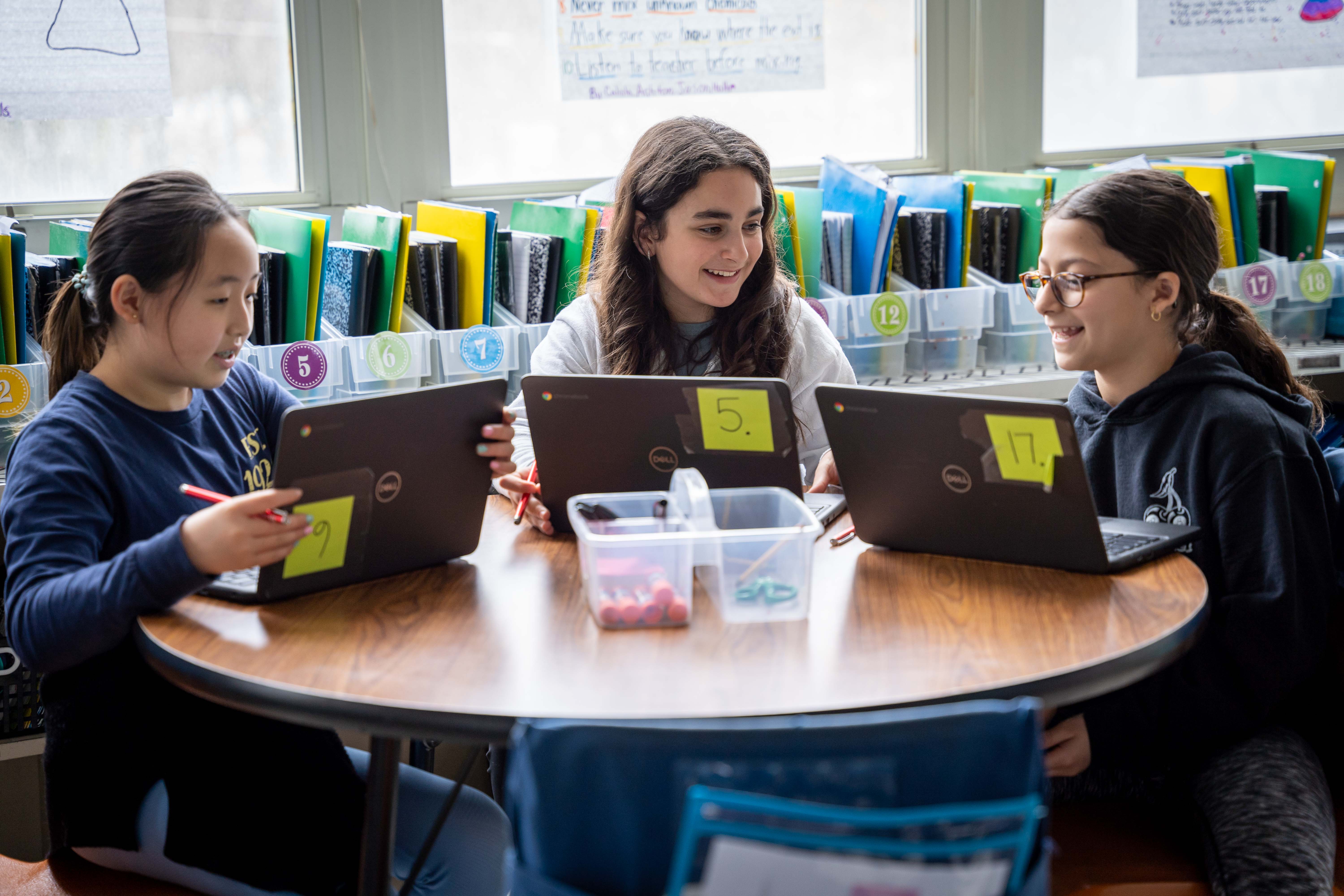 Three students are collaborating on solving math problems in Magma
