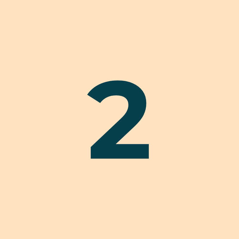 Large navy blue number two on a light peach background