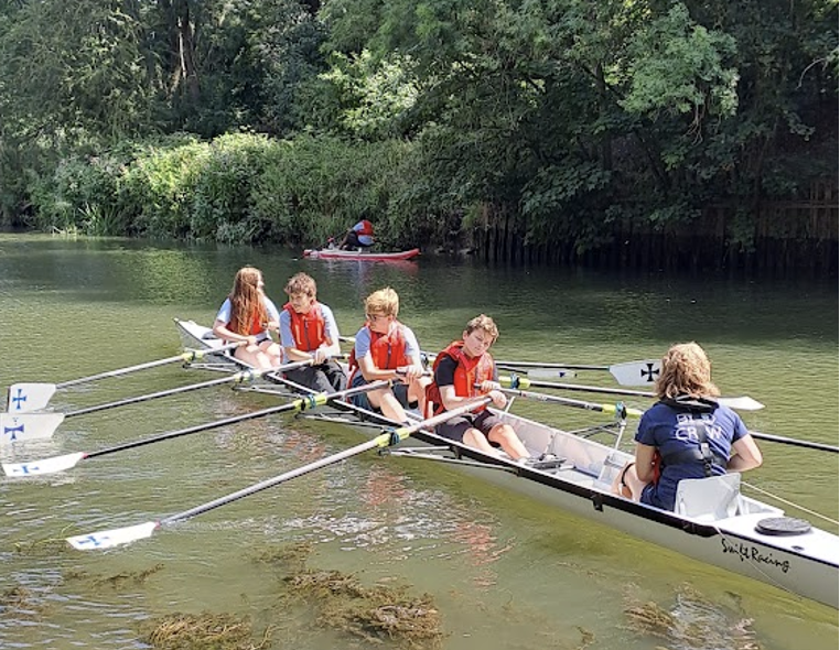 Smiling active row participant in lifejacket