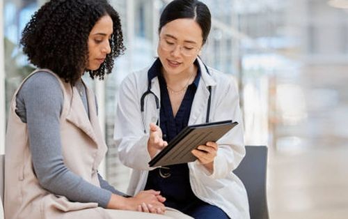 Patient and caregiver looking at iPad