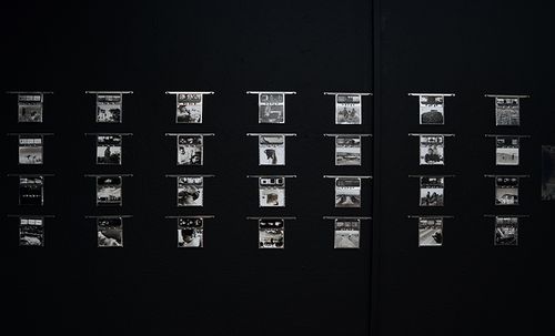 An array of photo processing hangers reused to present this body of work.