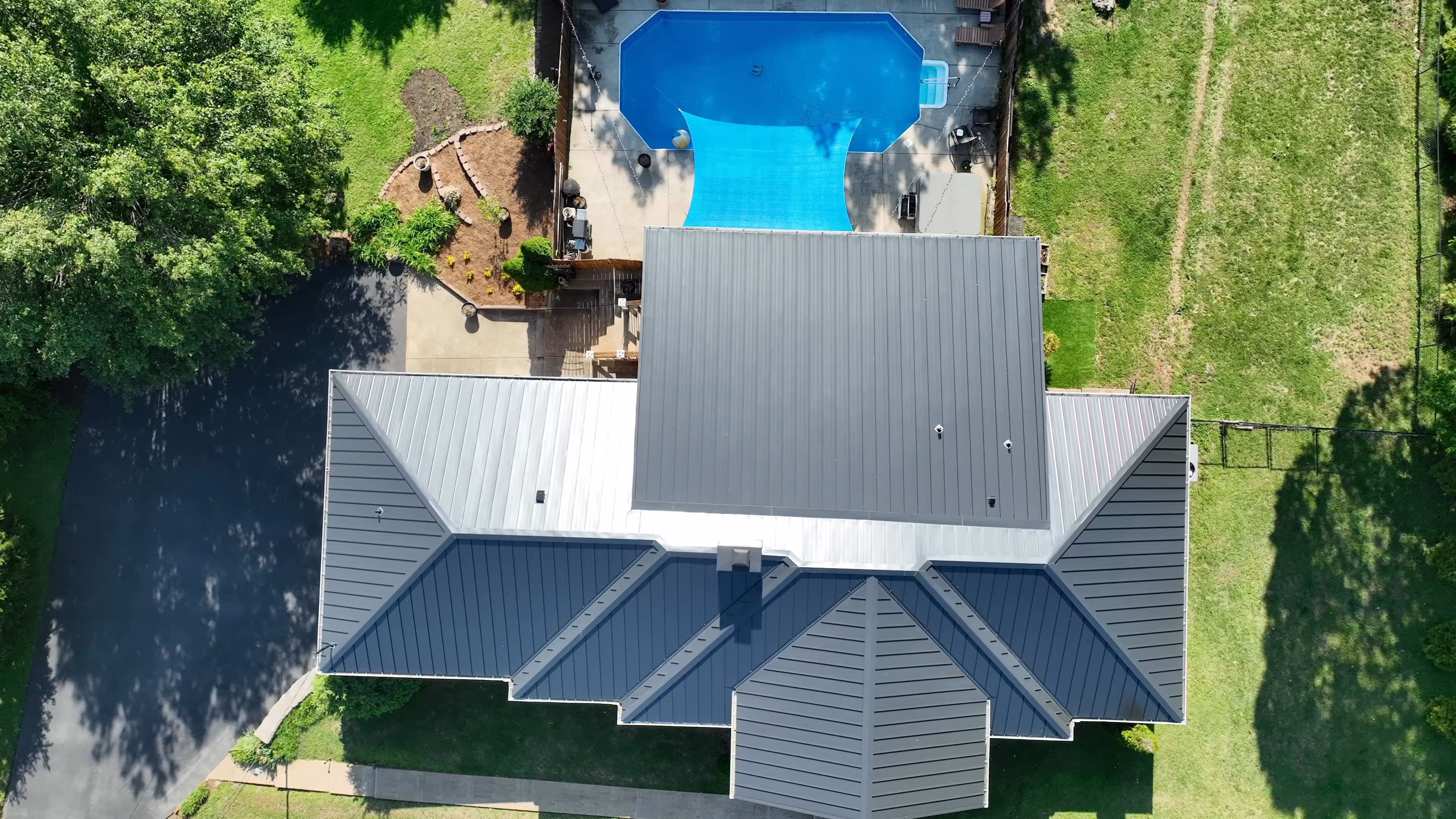 Black Standing Seam on Ranch Home With Pool