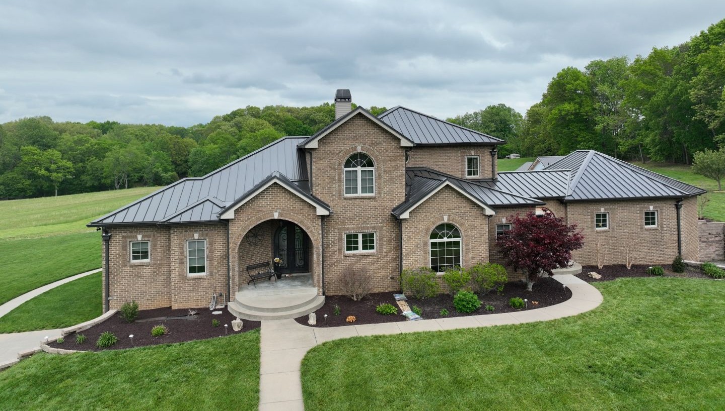 Tuscan-Style Brick Home with a Bronze Standing-Seam Roof