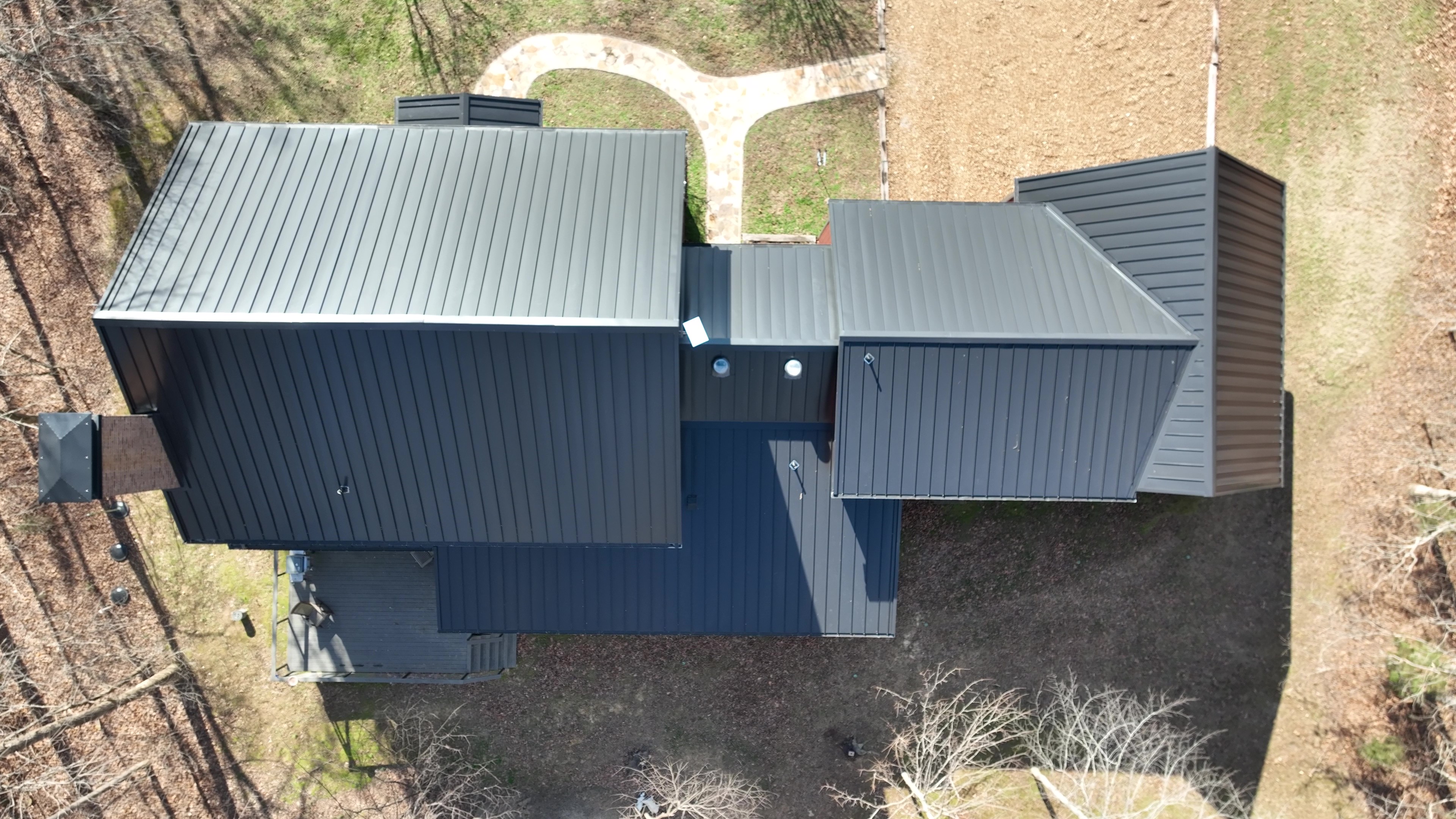 Dark Bronze Standing Seam Farm House in Treeline