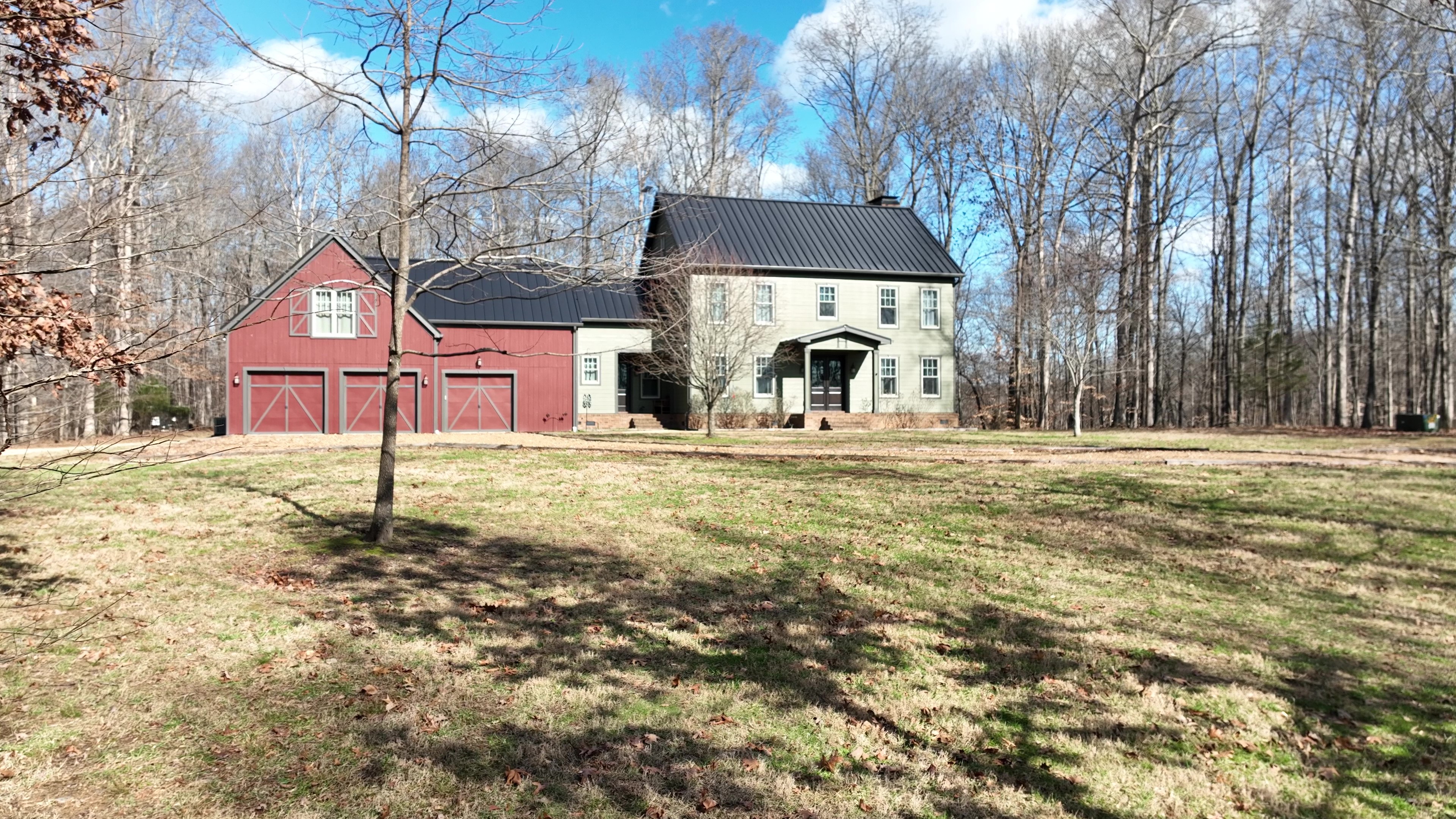 Dark Bronze Standing Seam Farm House in Treeline
