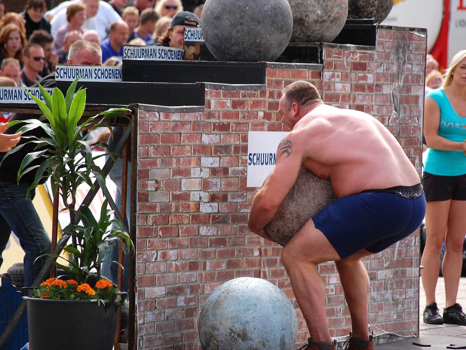 Strongman lifting an atlas stone