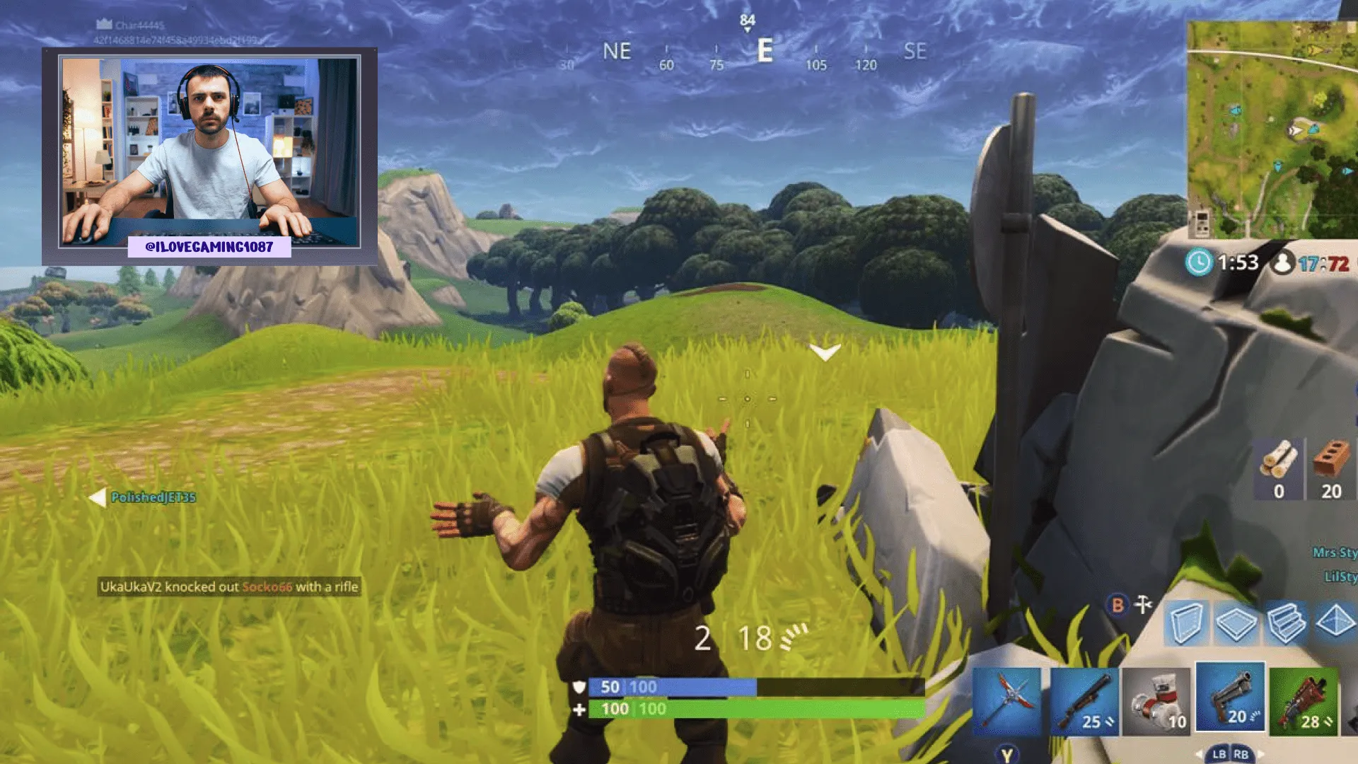 A still from live streamed gameplay, with a webcam feed of the gamer in the top left corner, framed by a webcam overlay.