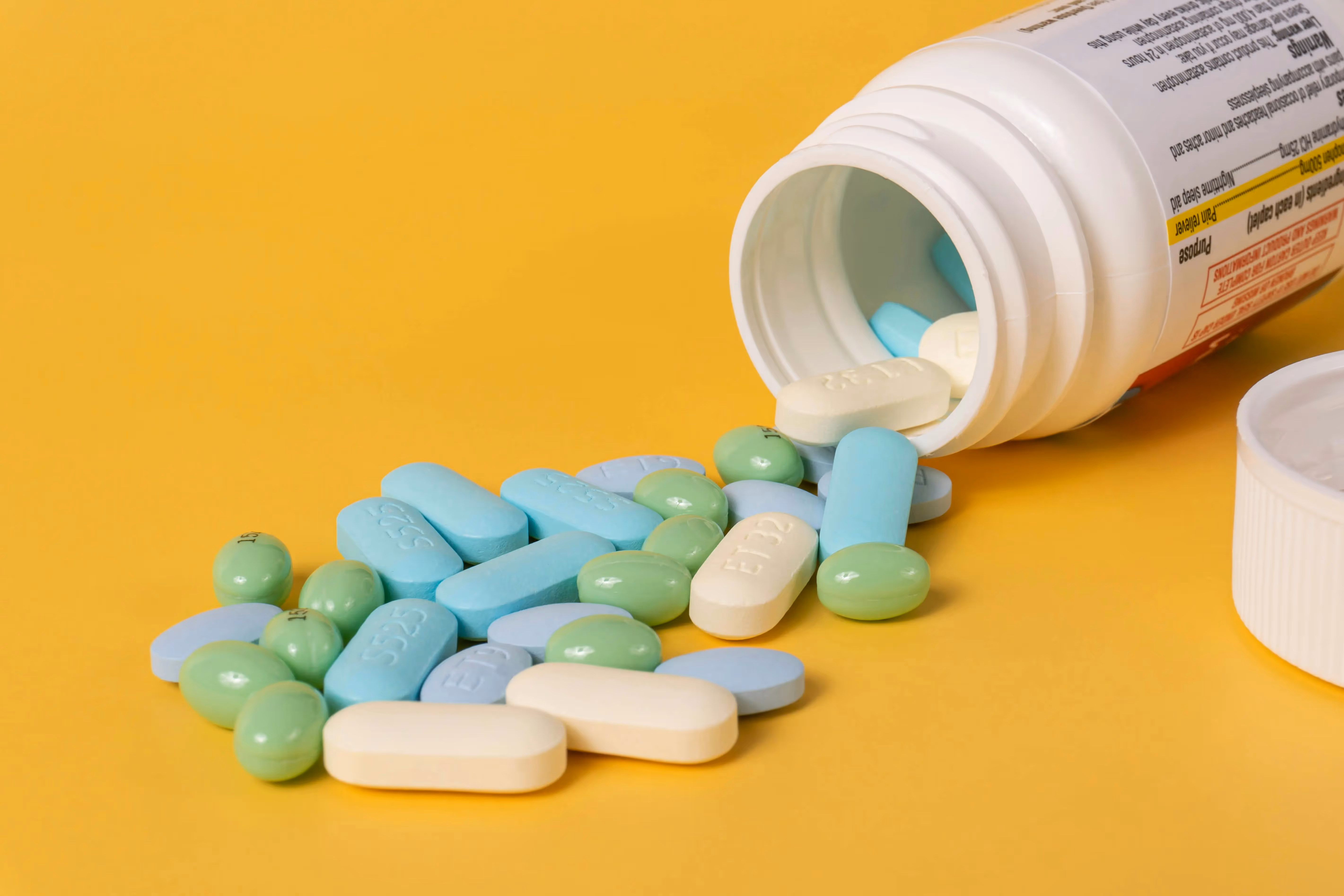 Pills spilling out of its bottle