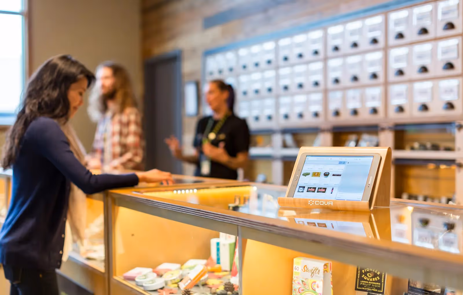 A woman standing at a store's counter
