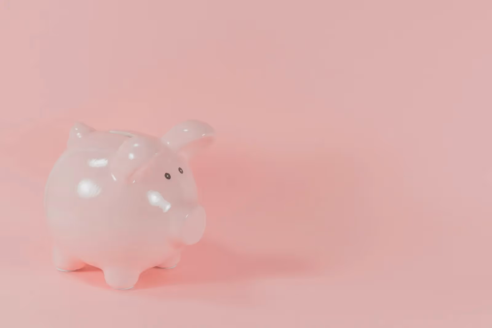 Pink piggybank with a pink background