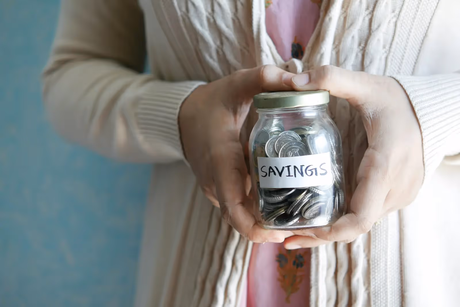 Woman holding a jar of coins