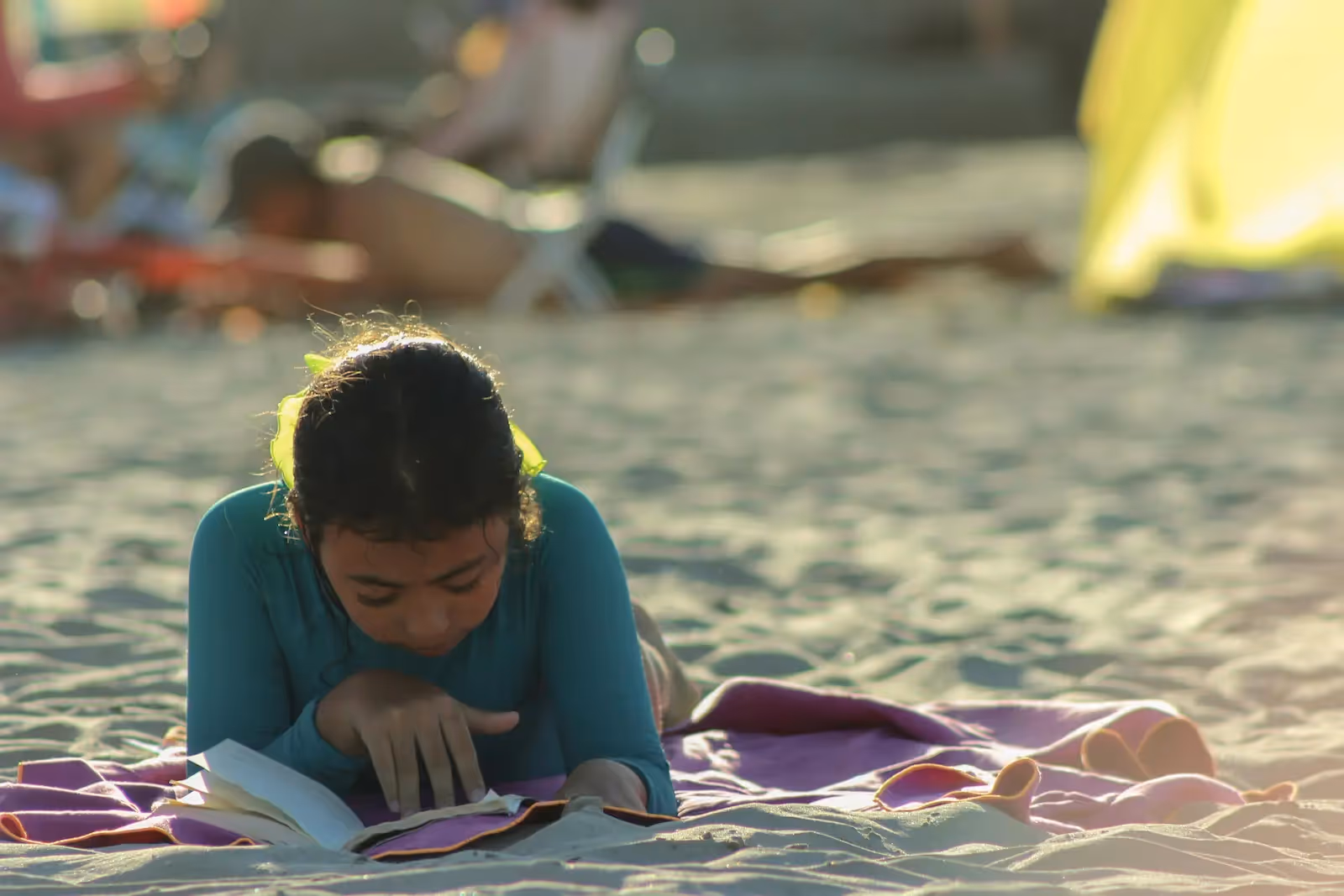 Girl reading a book in a beach