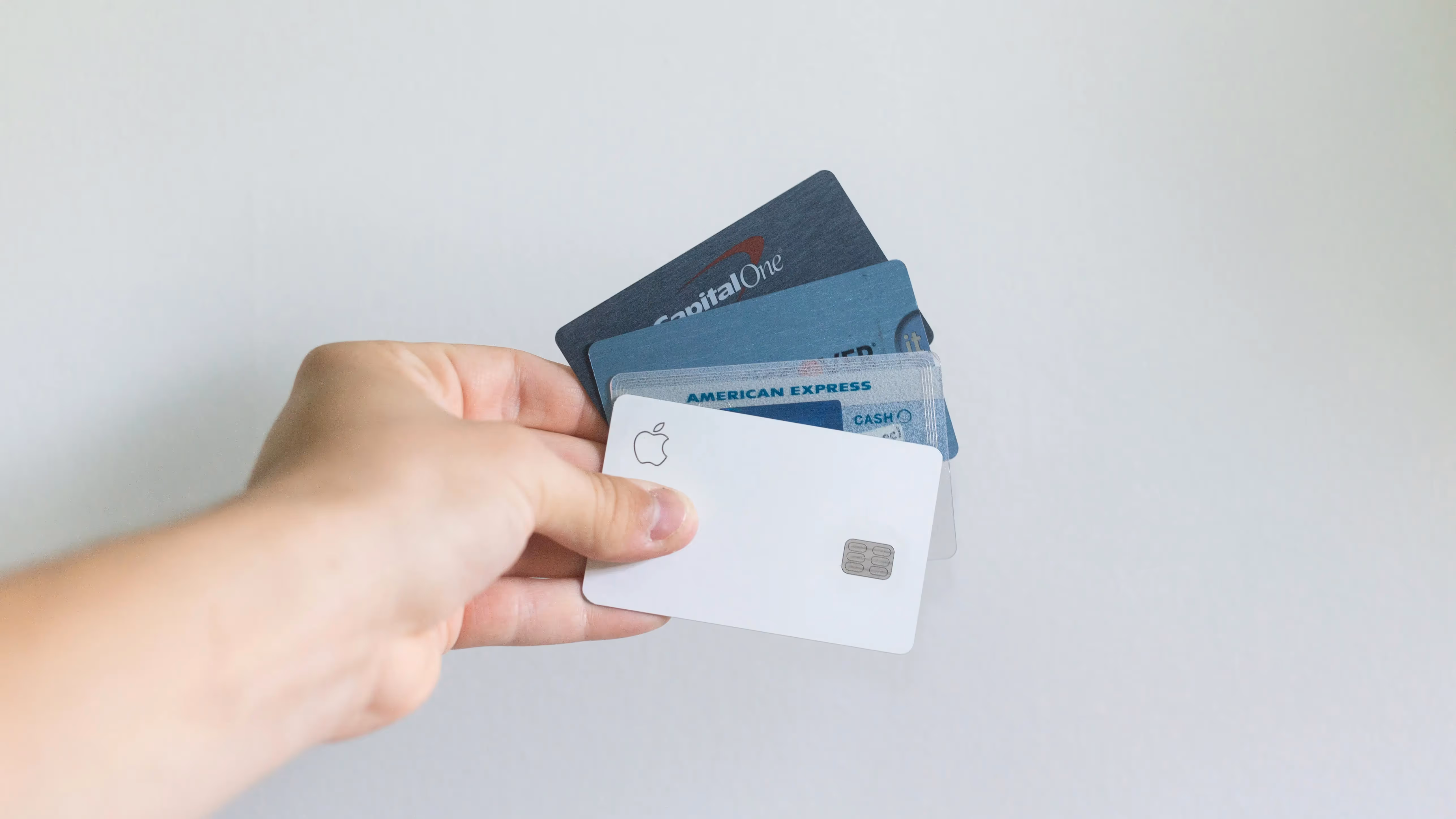 Person holding different credit cards