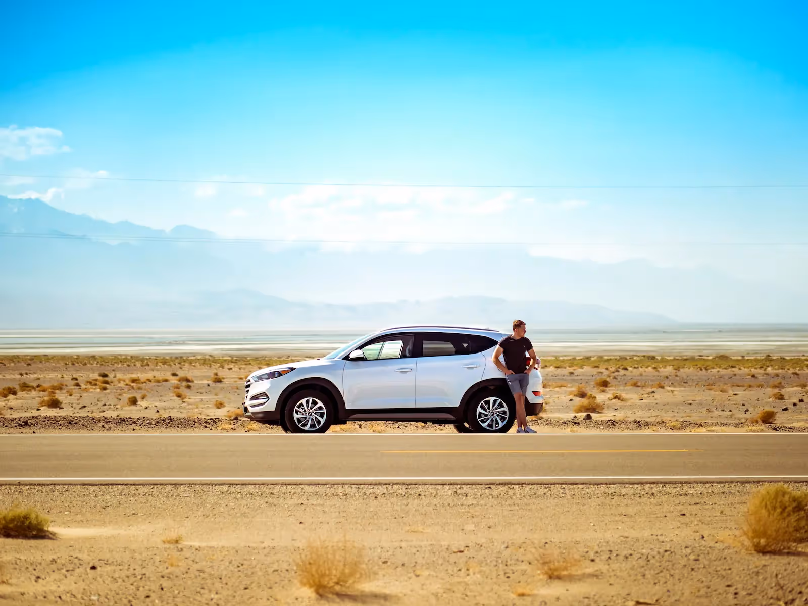 Man standing beside a car
