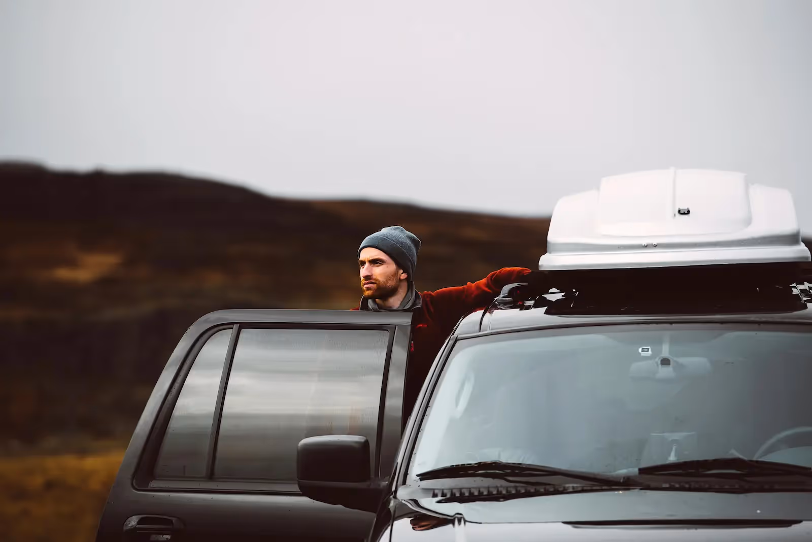 Man standing beside a car
