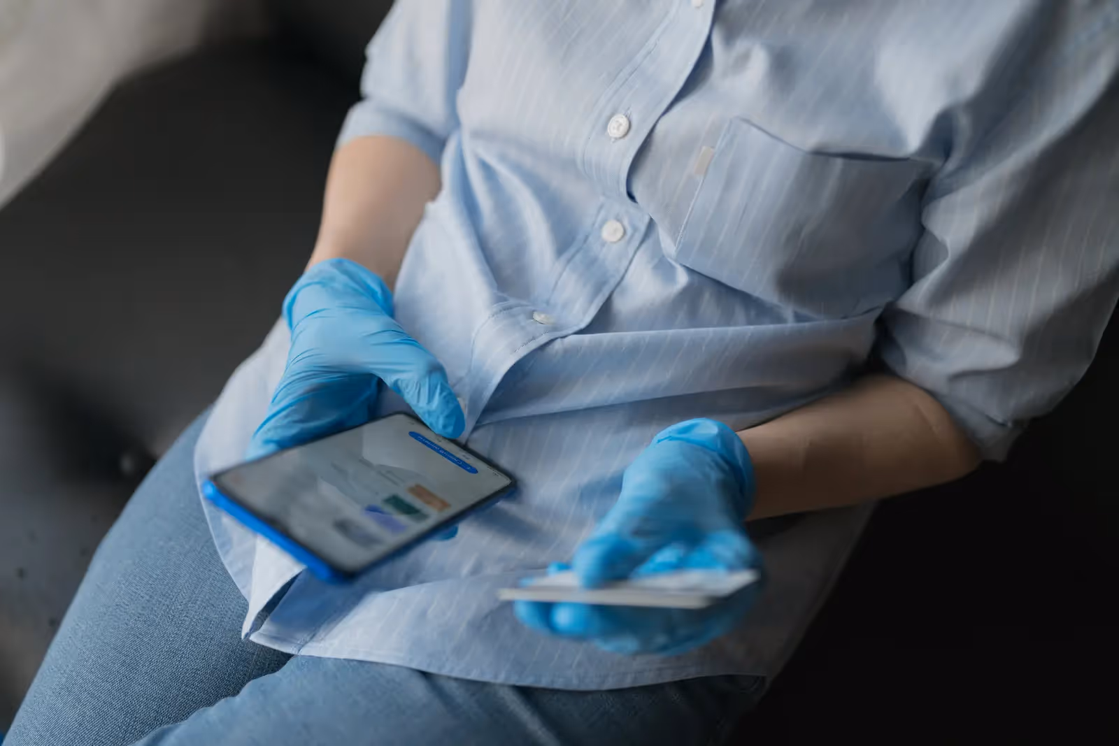 Person holding a phone and a credit card