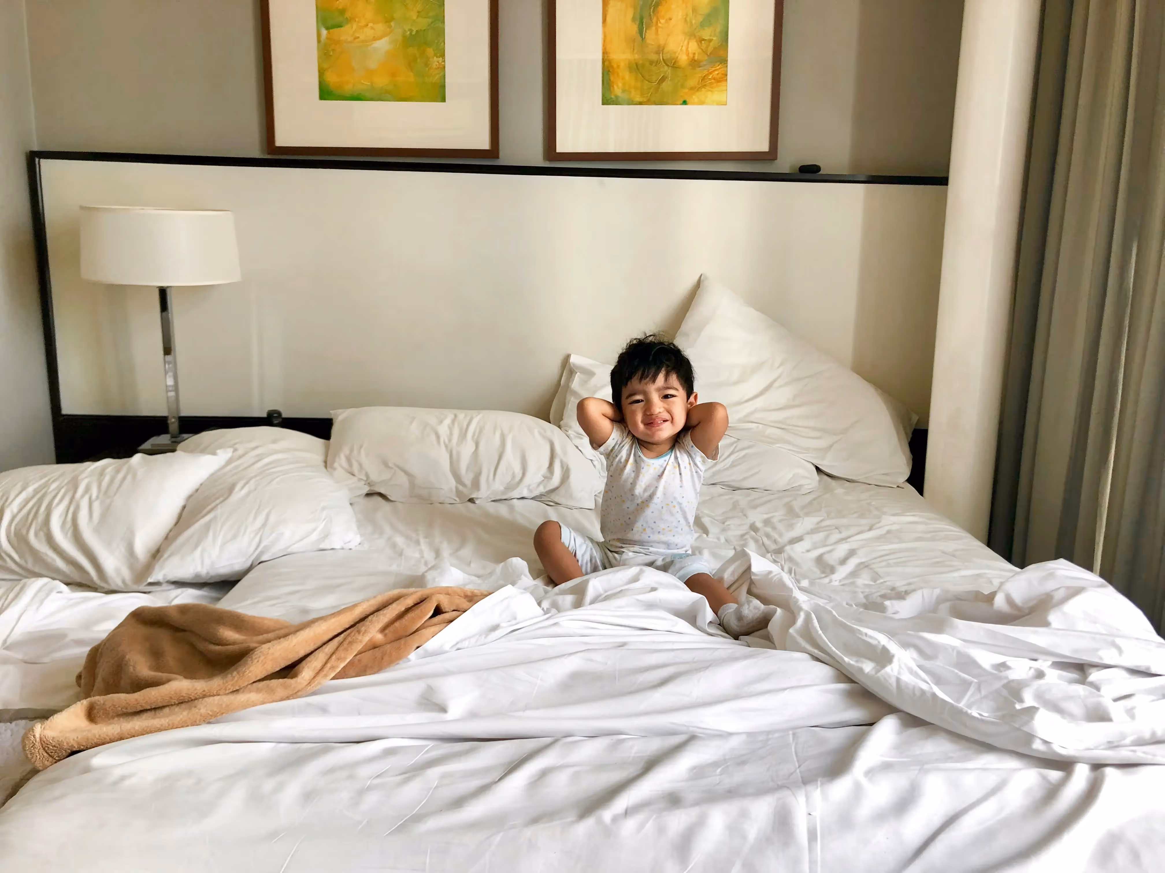 Toddler on a hotel bed