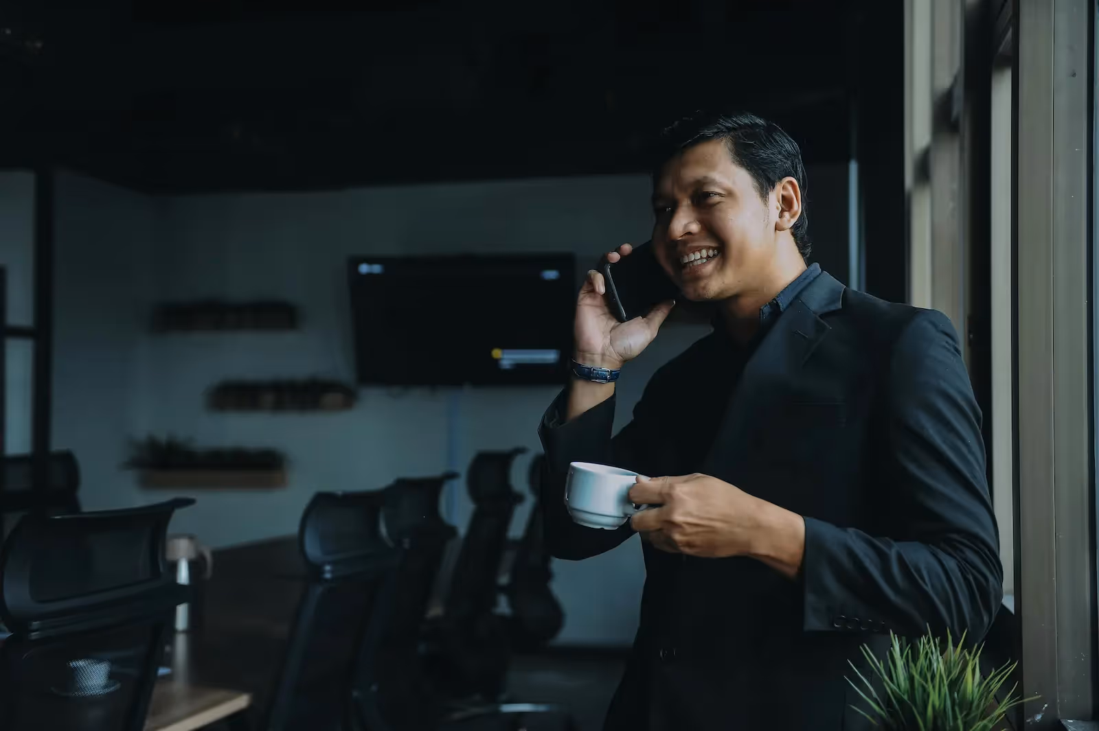 Person holding a cup and a phone