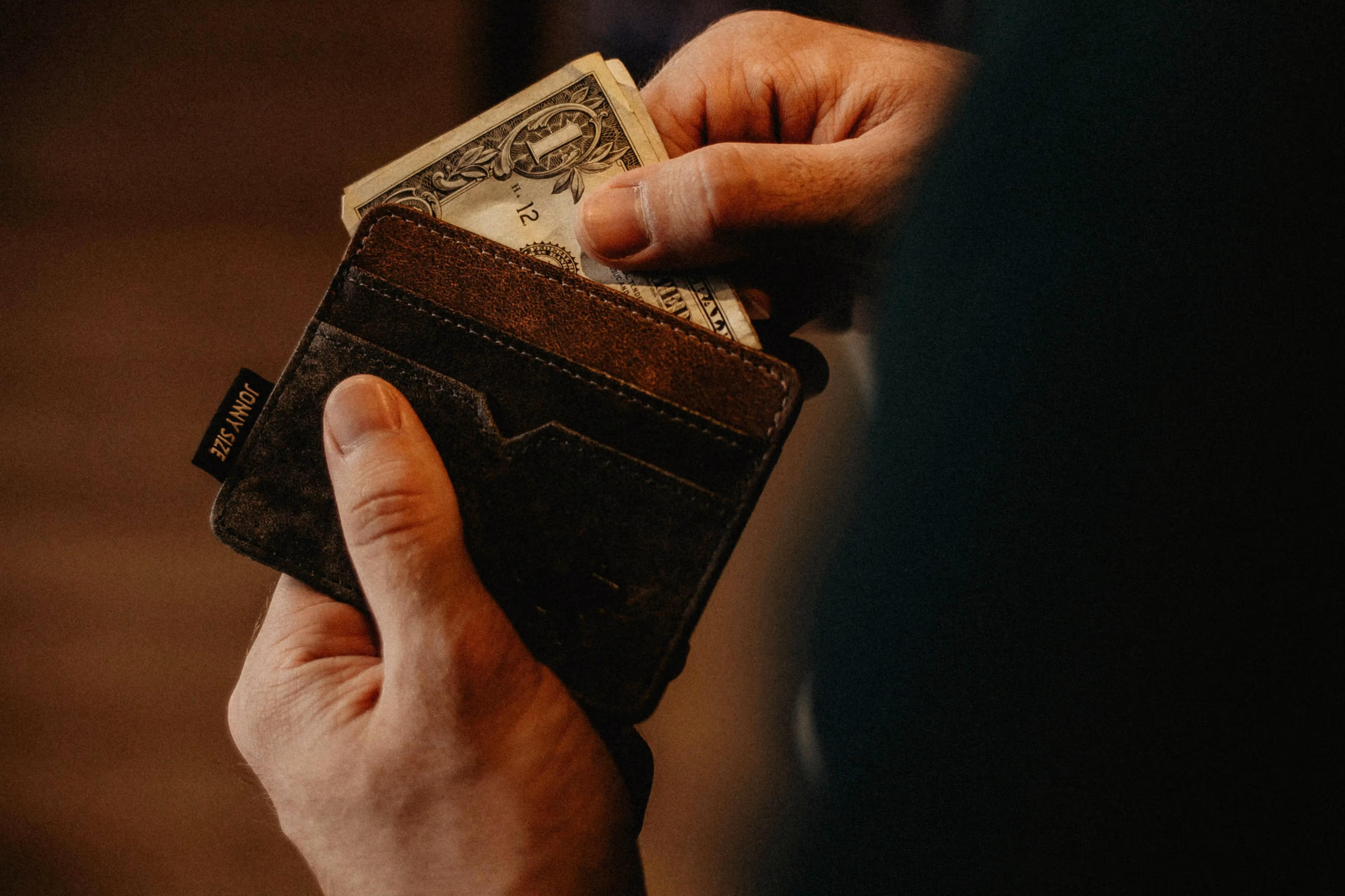 Person holding a wallet 