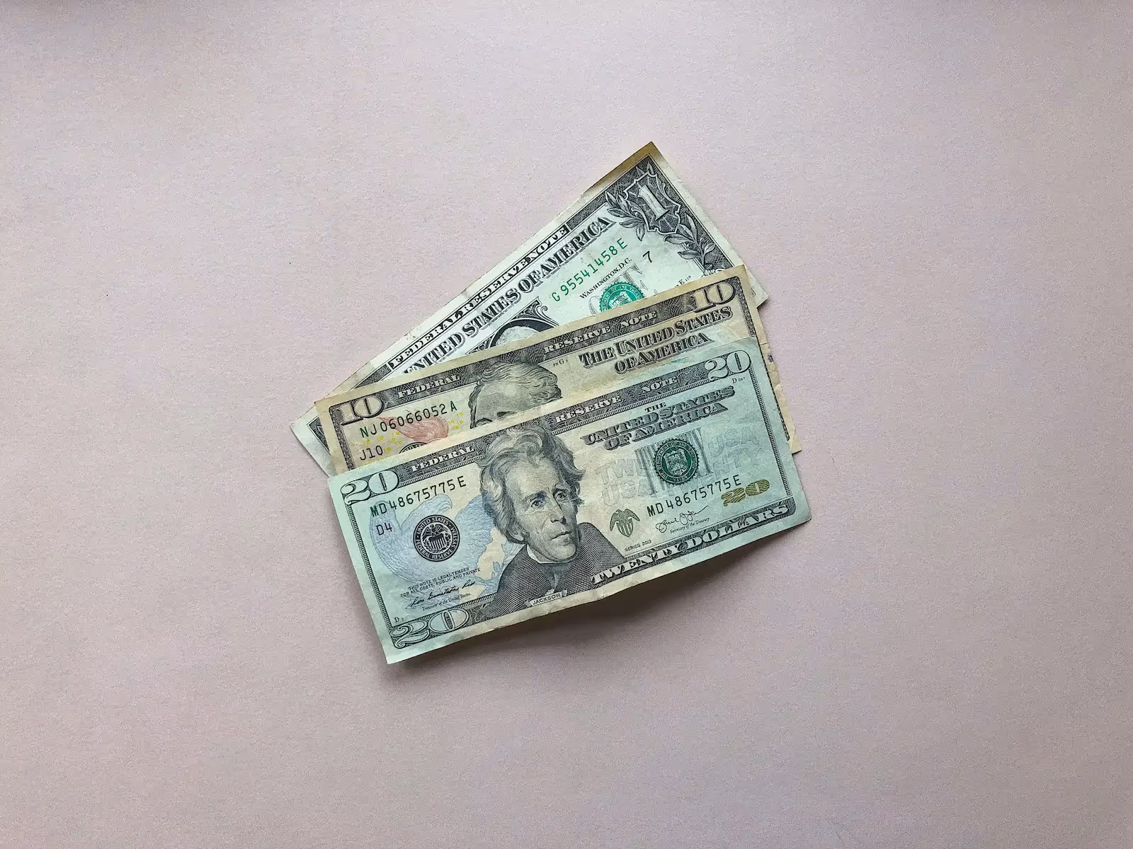 Money on a pink surface