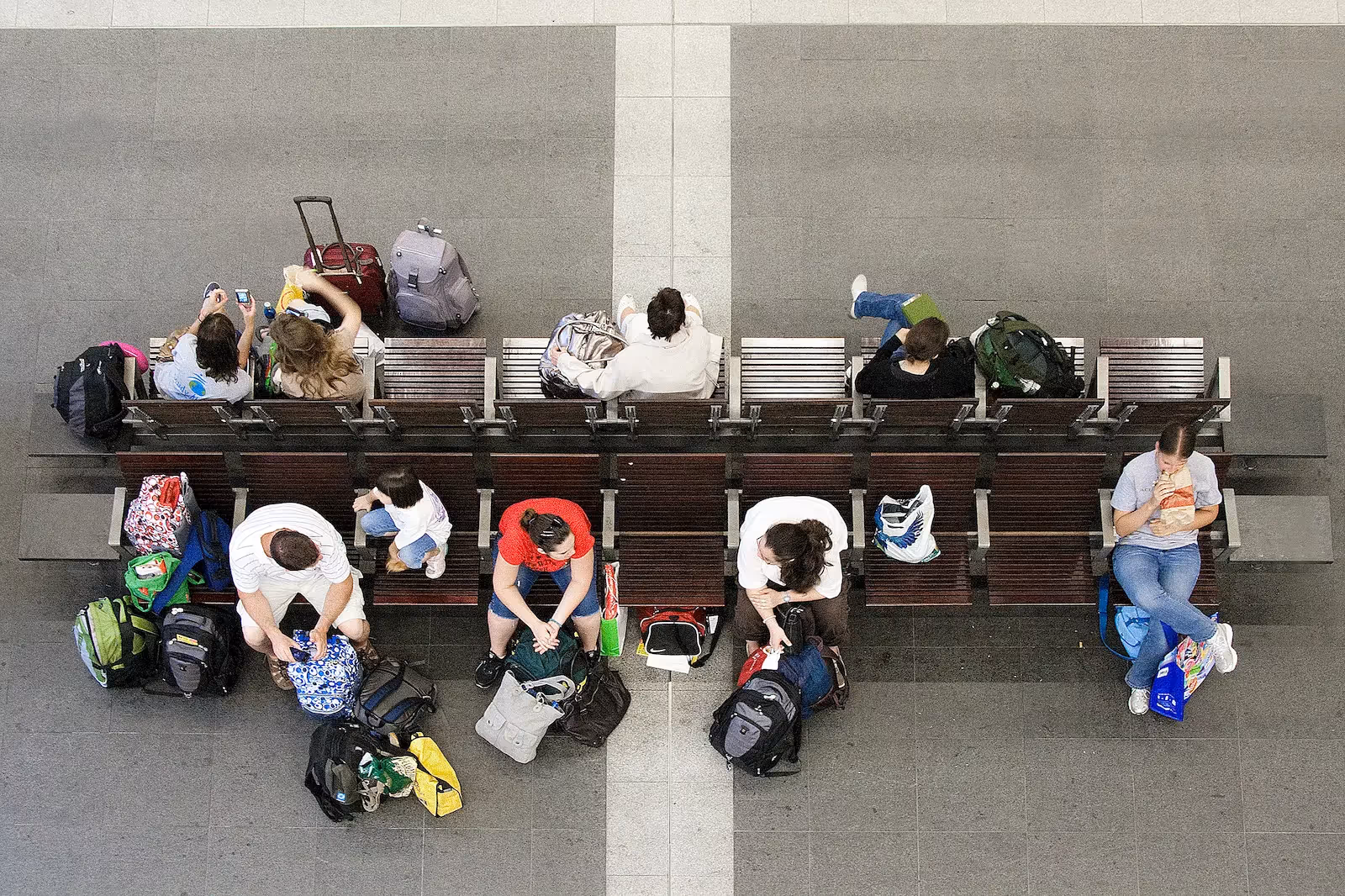 People sitting with their bags