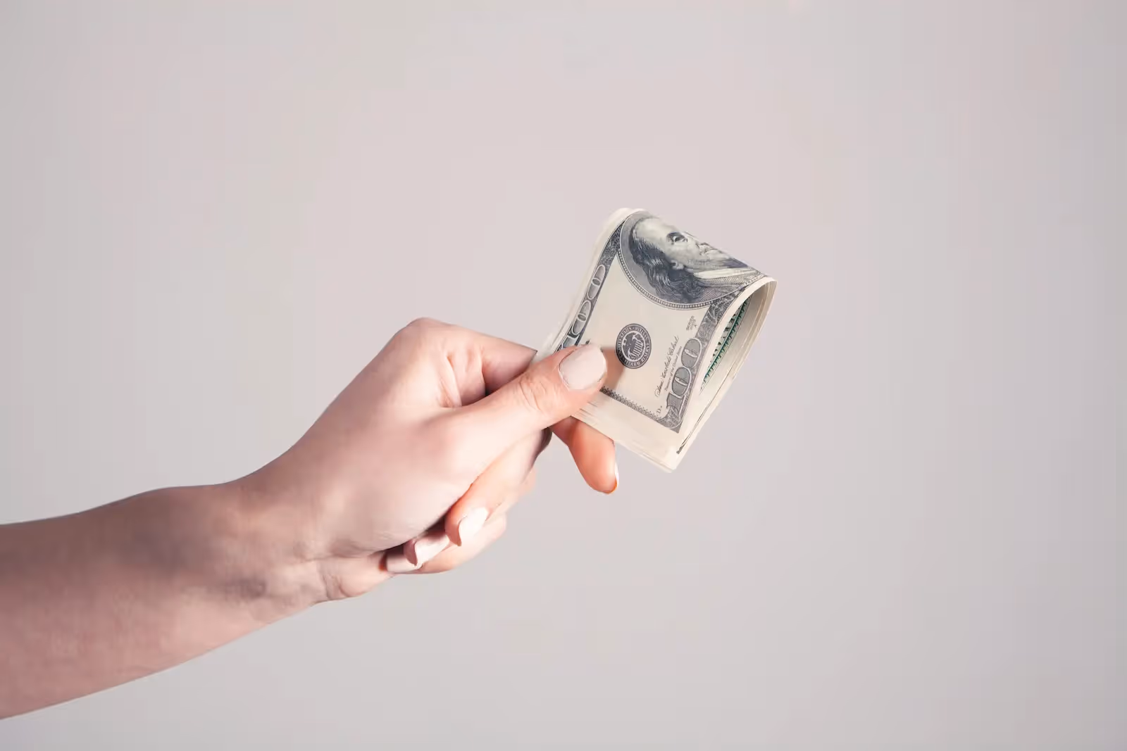 Person holding a dollar bill