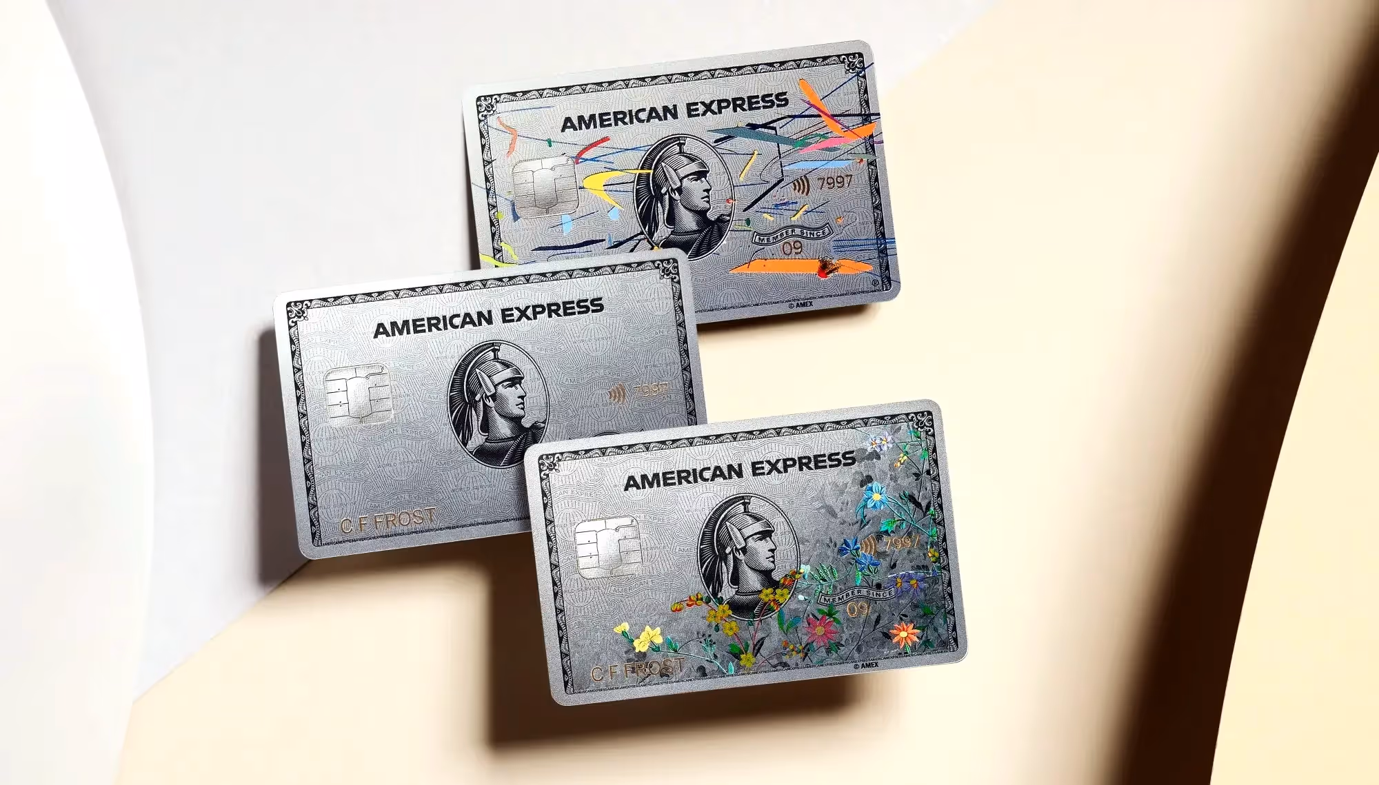 Three AMEX cards on a surface