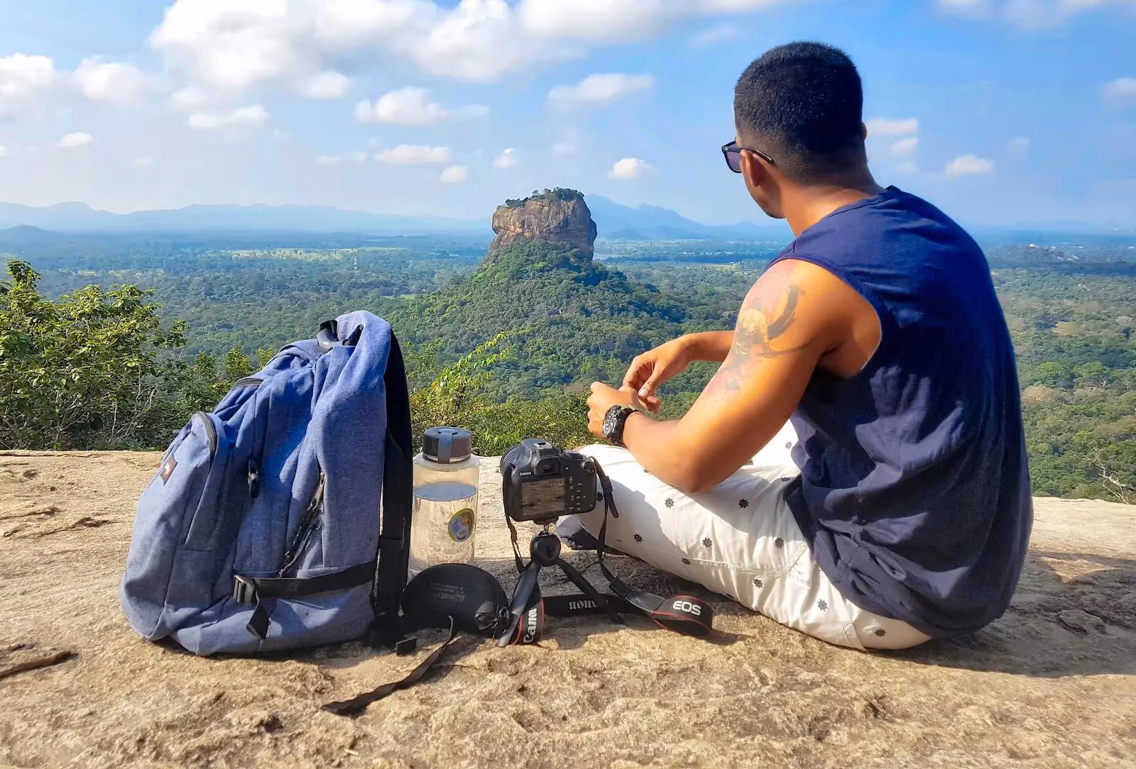 Person sitting beside a bag