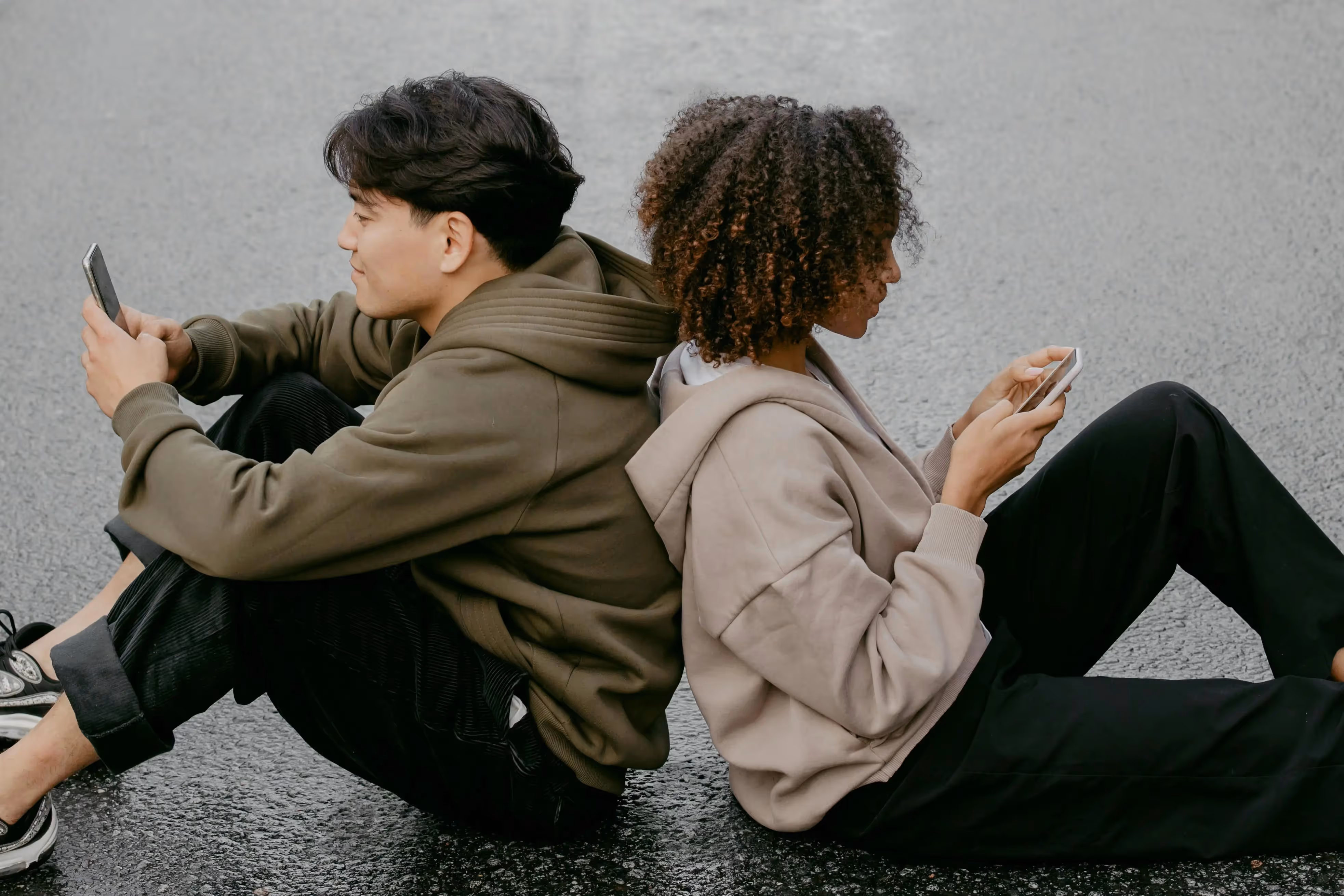 Two people using their phones