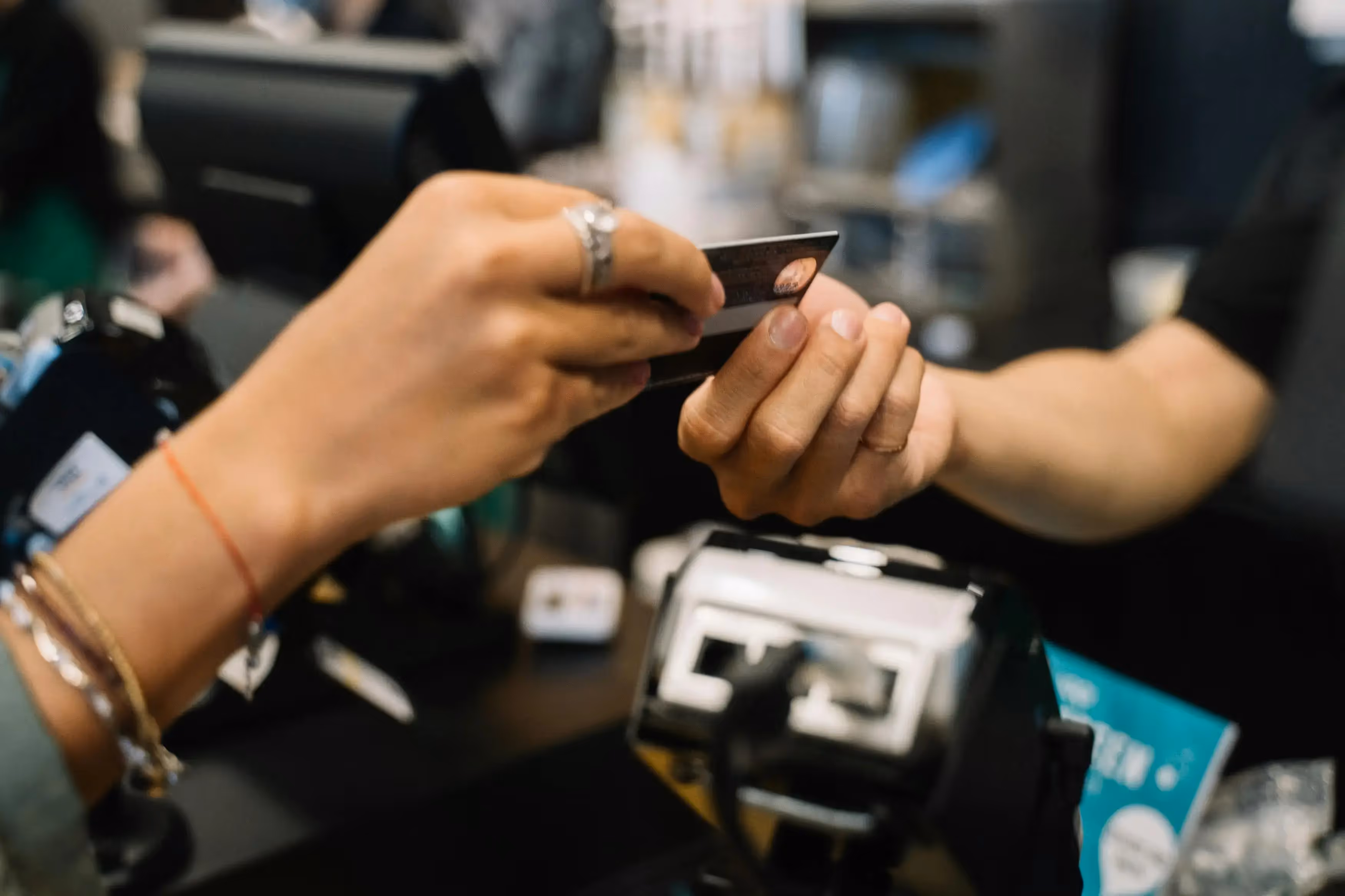 Person handing a card to another person
