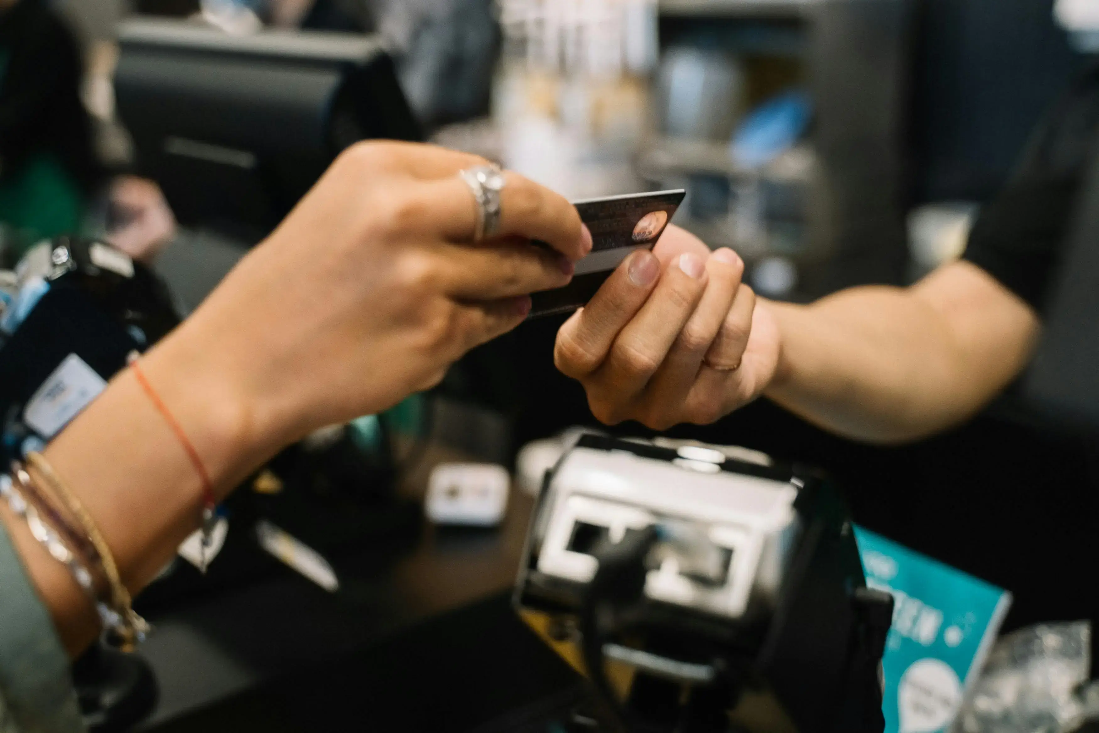 Person handing a card to another person