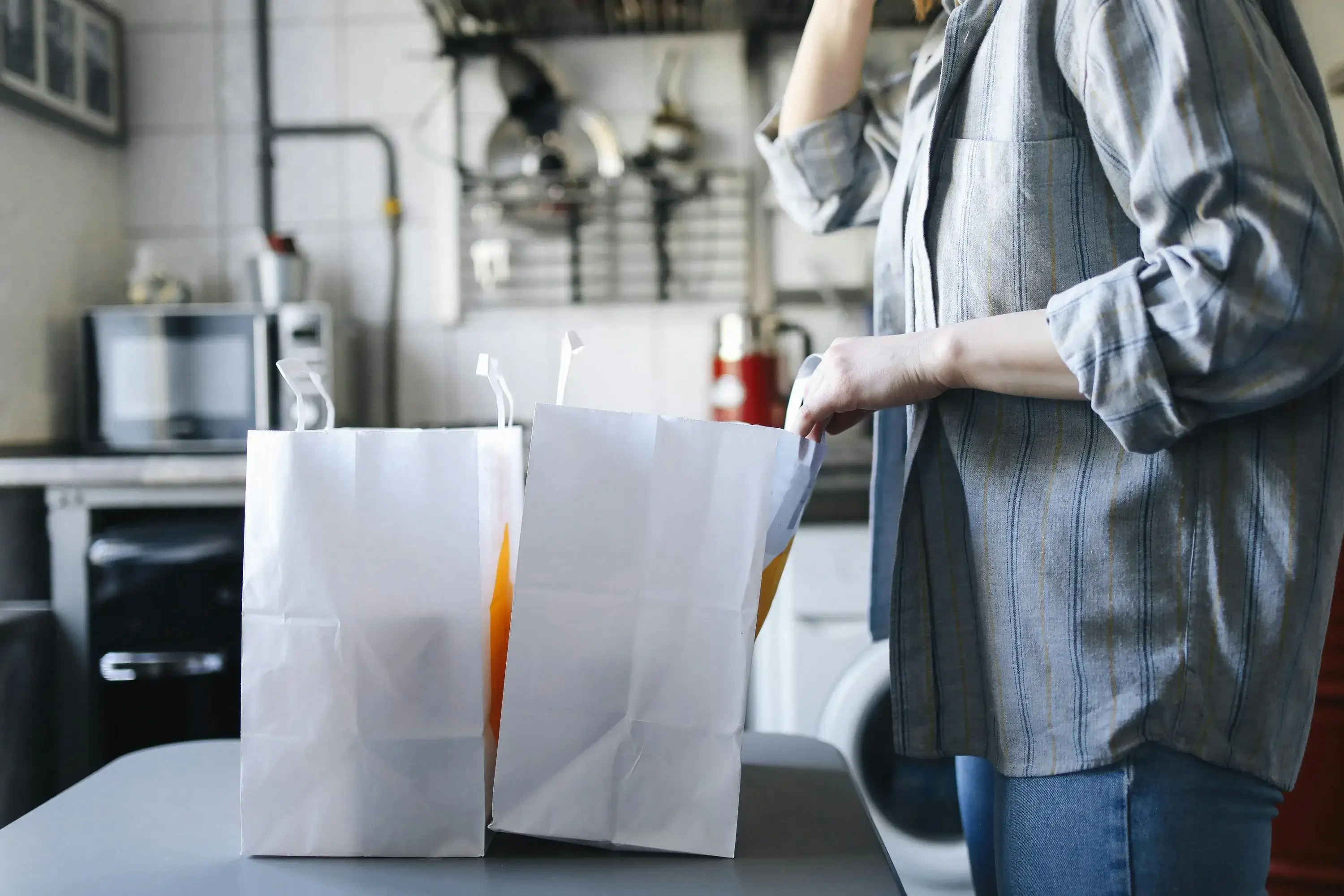 Person and two paper bags