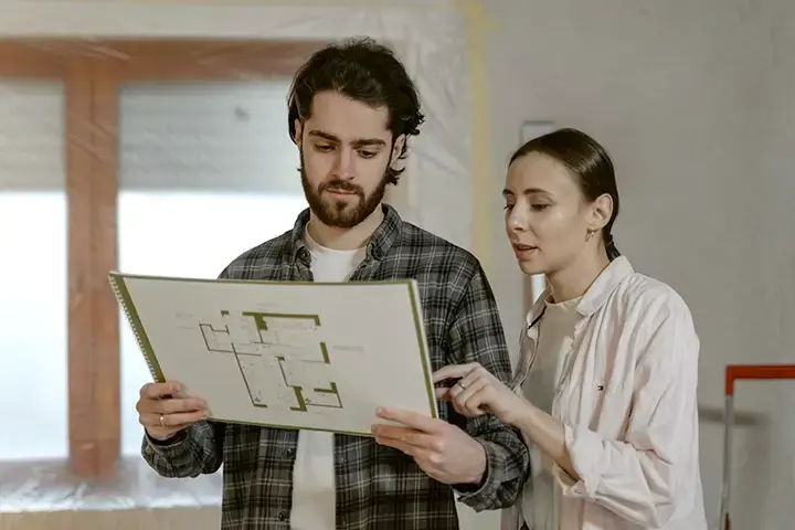 Two people and a floor plan