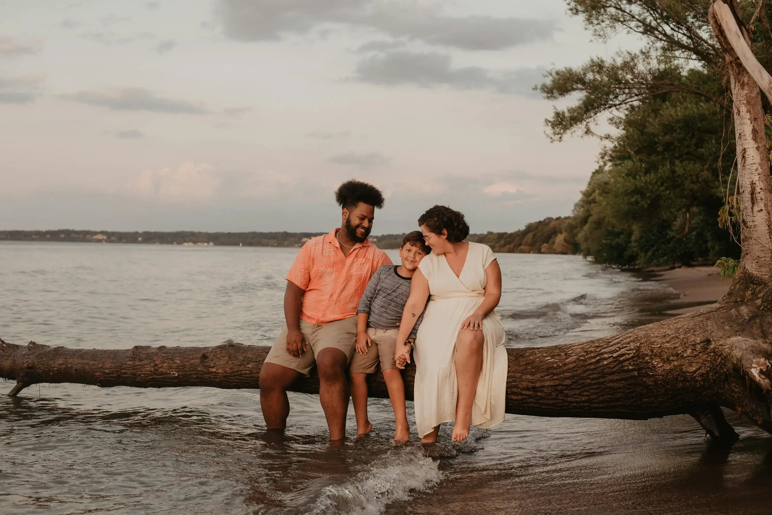 Family sitting on a tree log