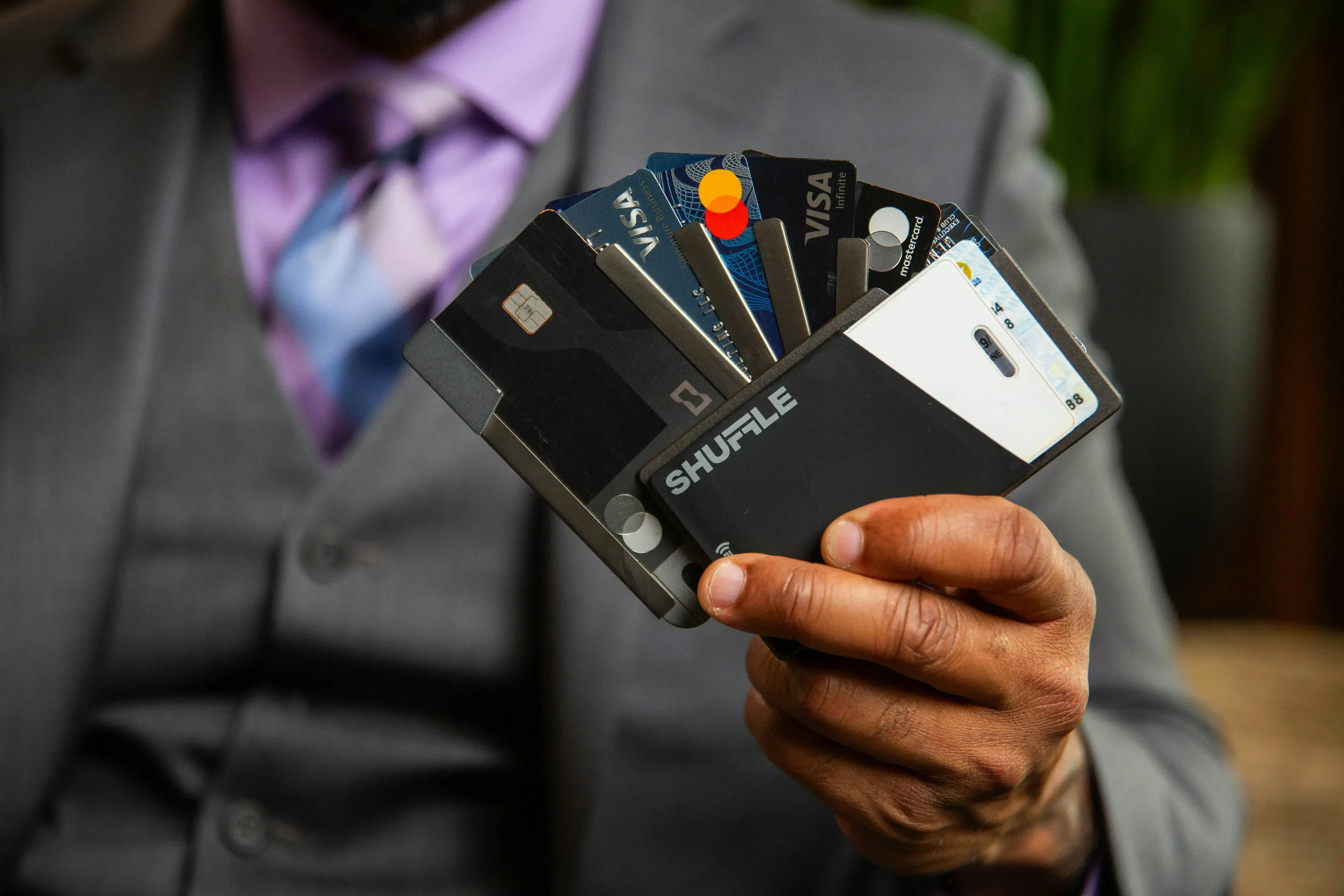 Man holding a variety of credit cards