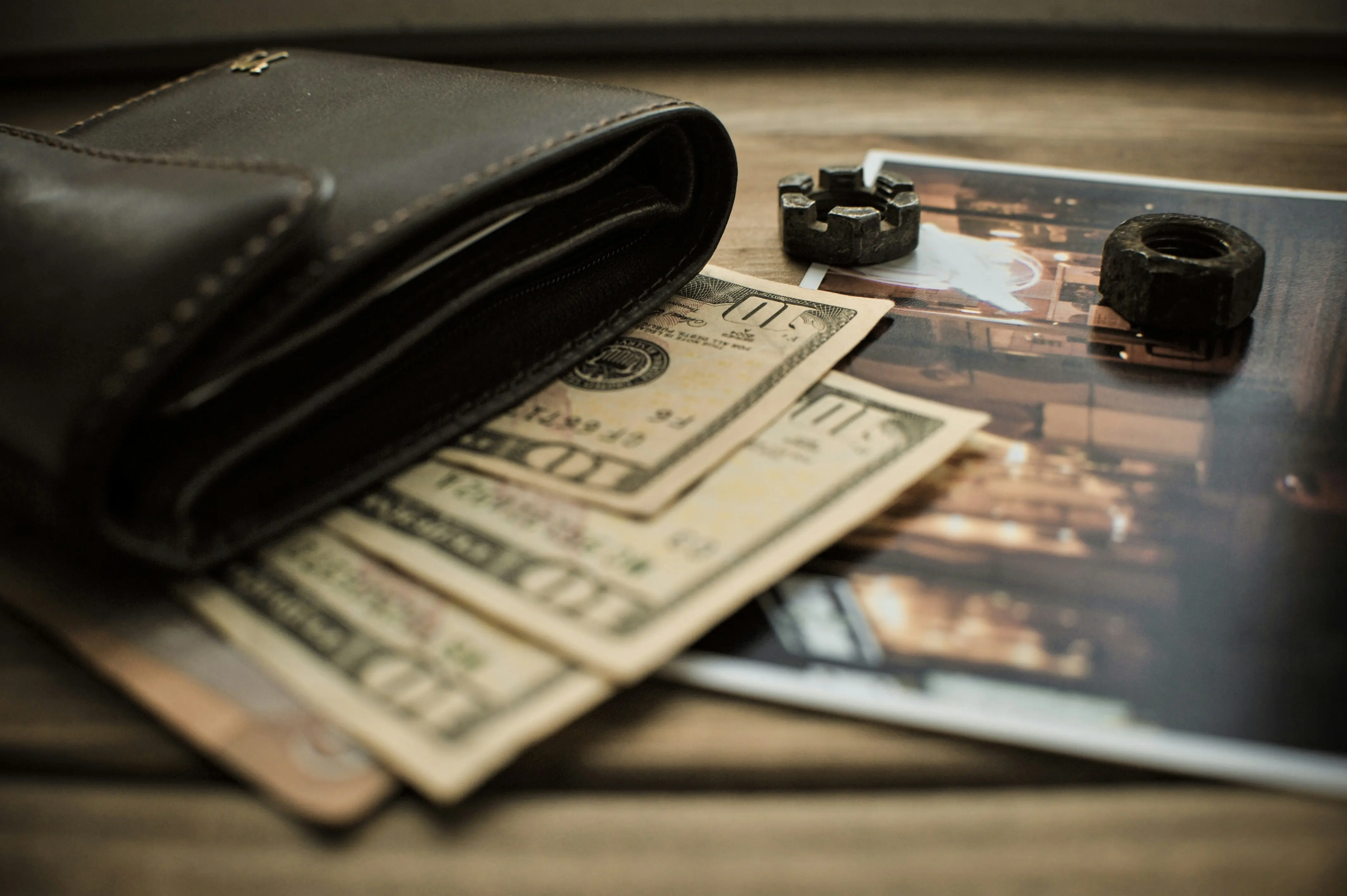 Wallet and money on a wooden surface
