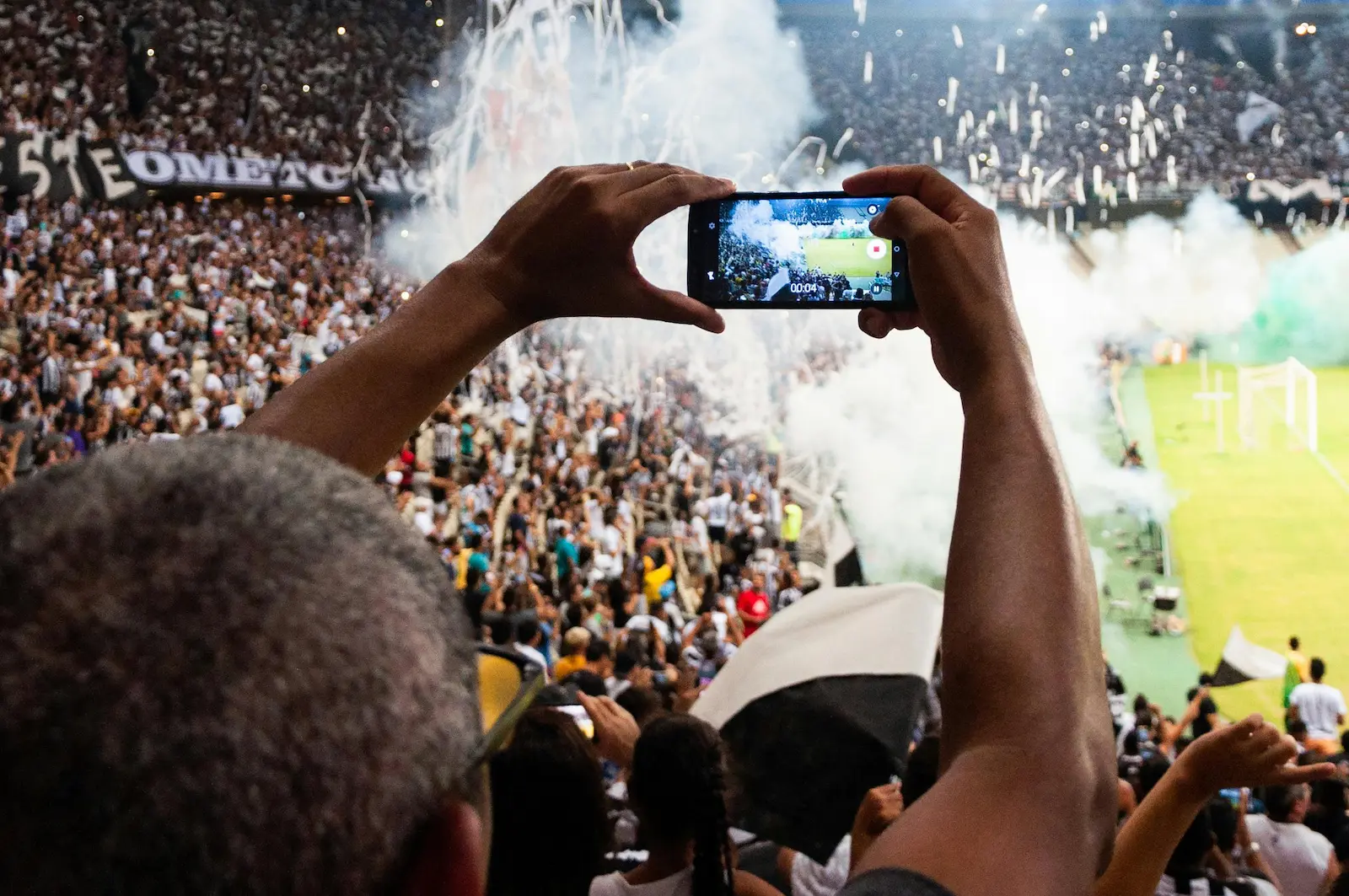 Person taking a photo in a stadium