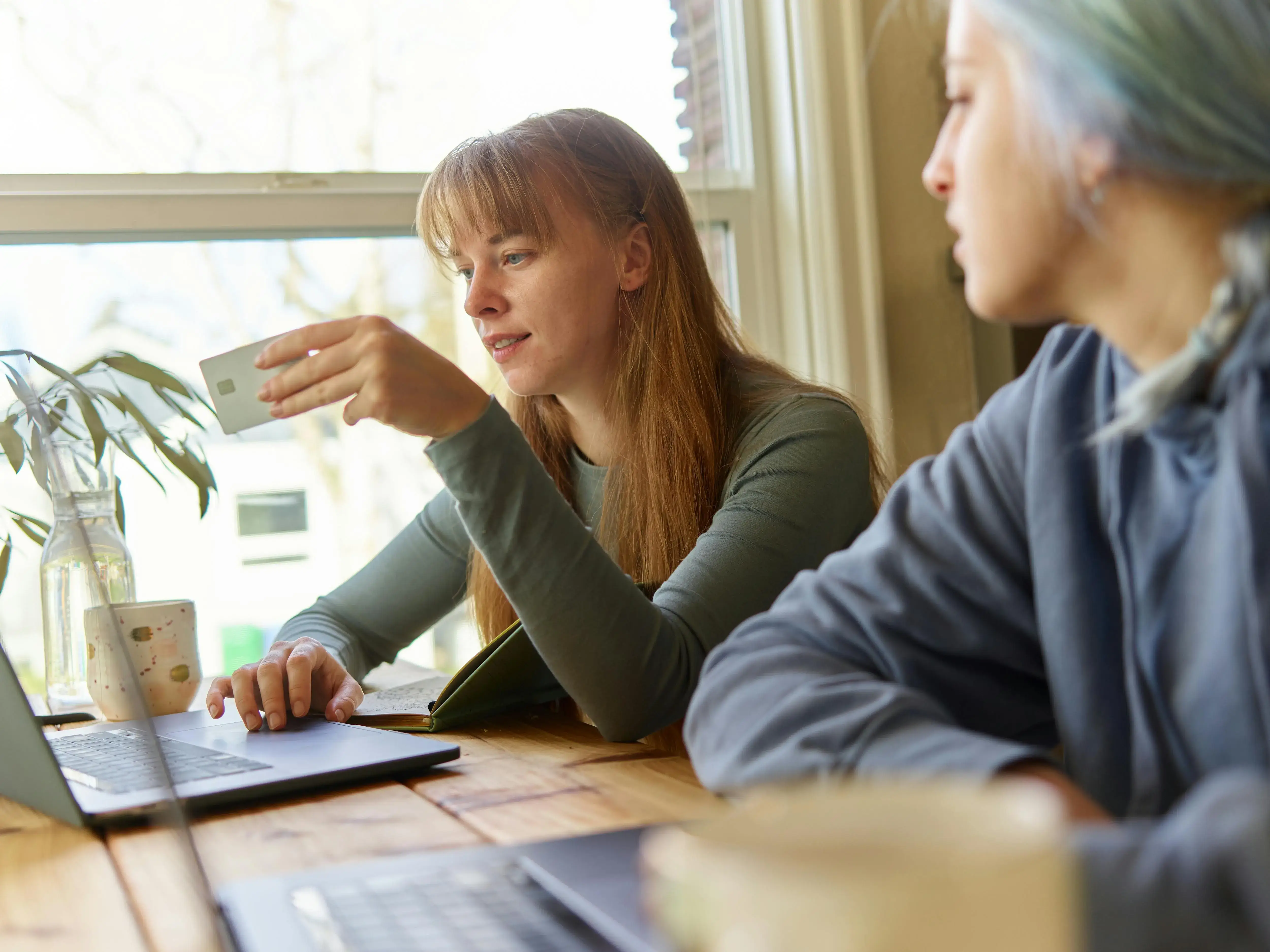 Two people using a laptop