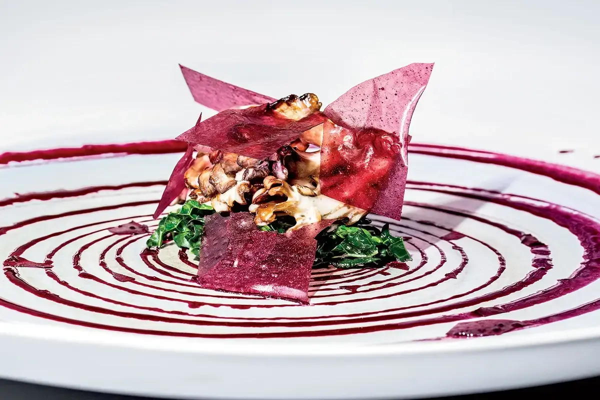 Elegantly plated dish at an upscale restaurant representing American Express Resy dining credit benefits