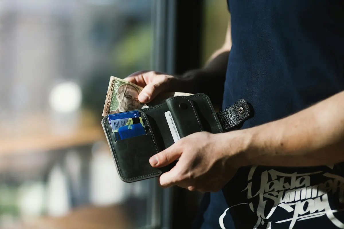 Person managing multiple American Express cards to maximize Amex Offers savings 2026